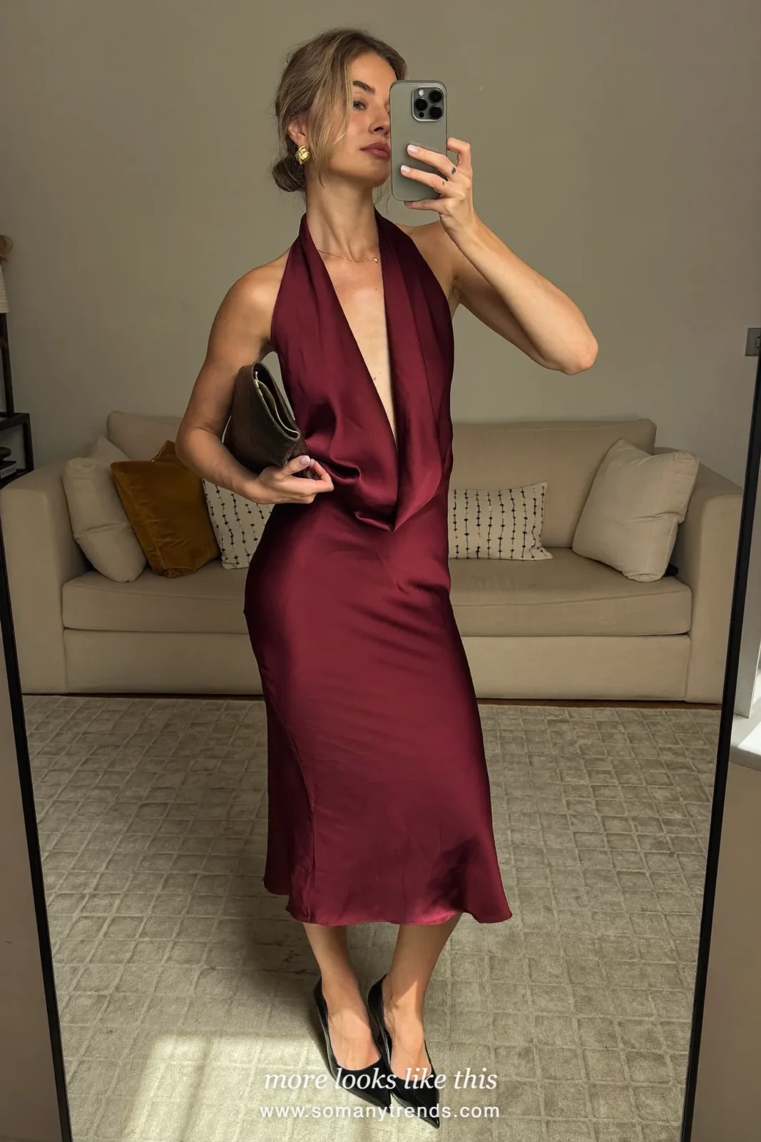 Woman in a burgundy satin halter midi dress, black pumps and gold earrings, cocktail outfit 20