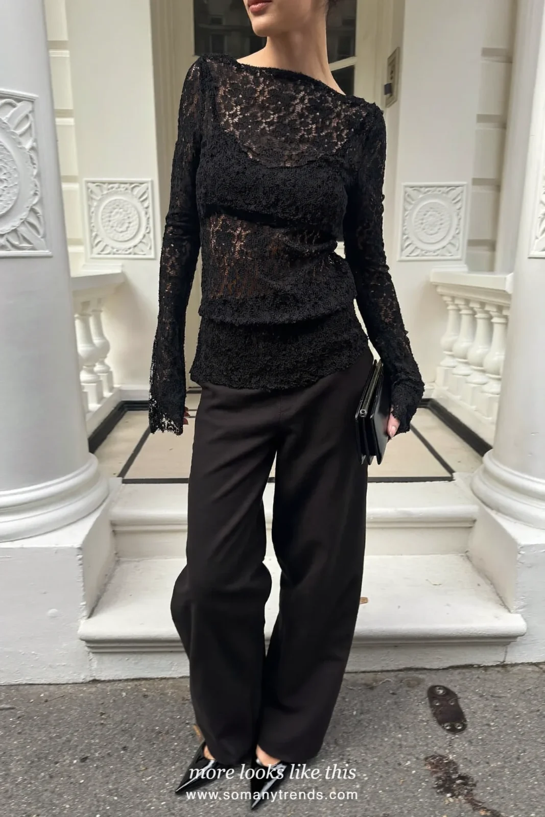 Woman in a lined black lace top, wide black pants and pointed pumps, cocktail outfit 30