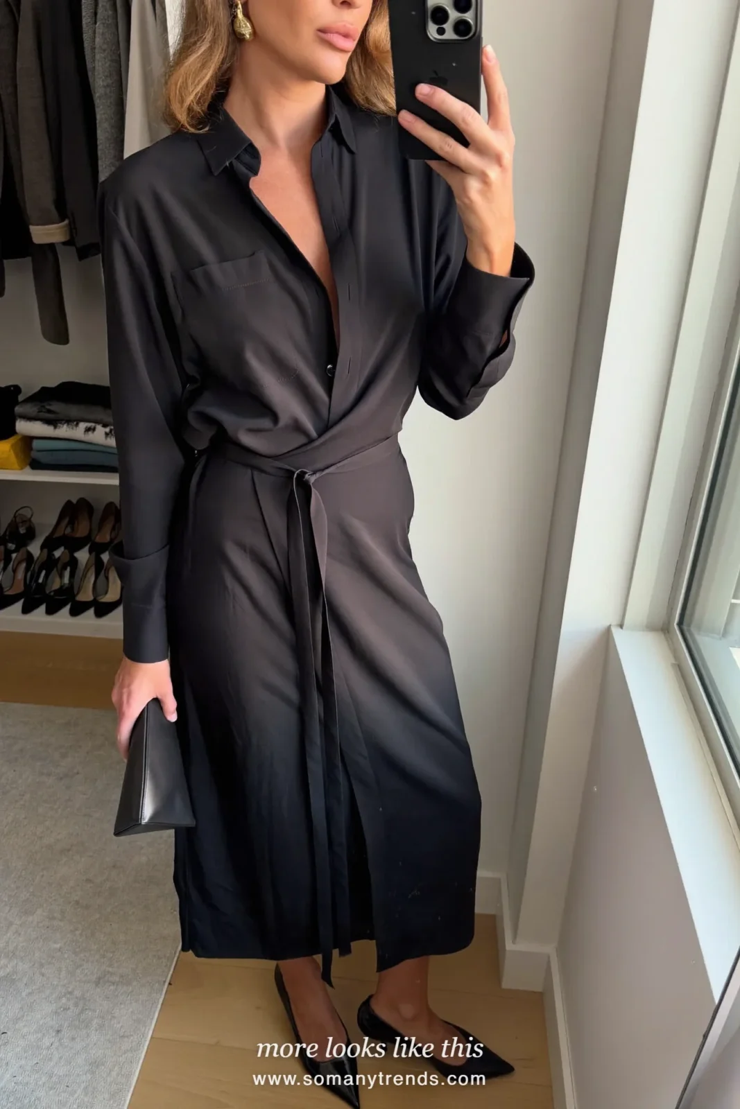 Woman in a black satin wrap midi dress, black pumps and a clutch, cocktail outfit 32