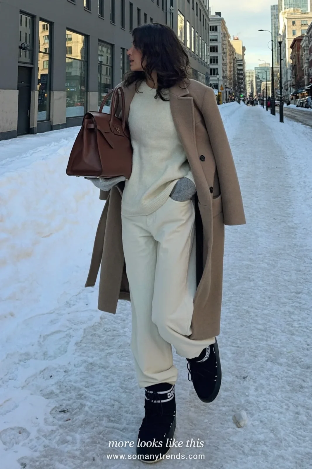 Long camel wool coat with cream knit, ivory pants, cashmere socks and snow boots on a snowy street, outfit 13