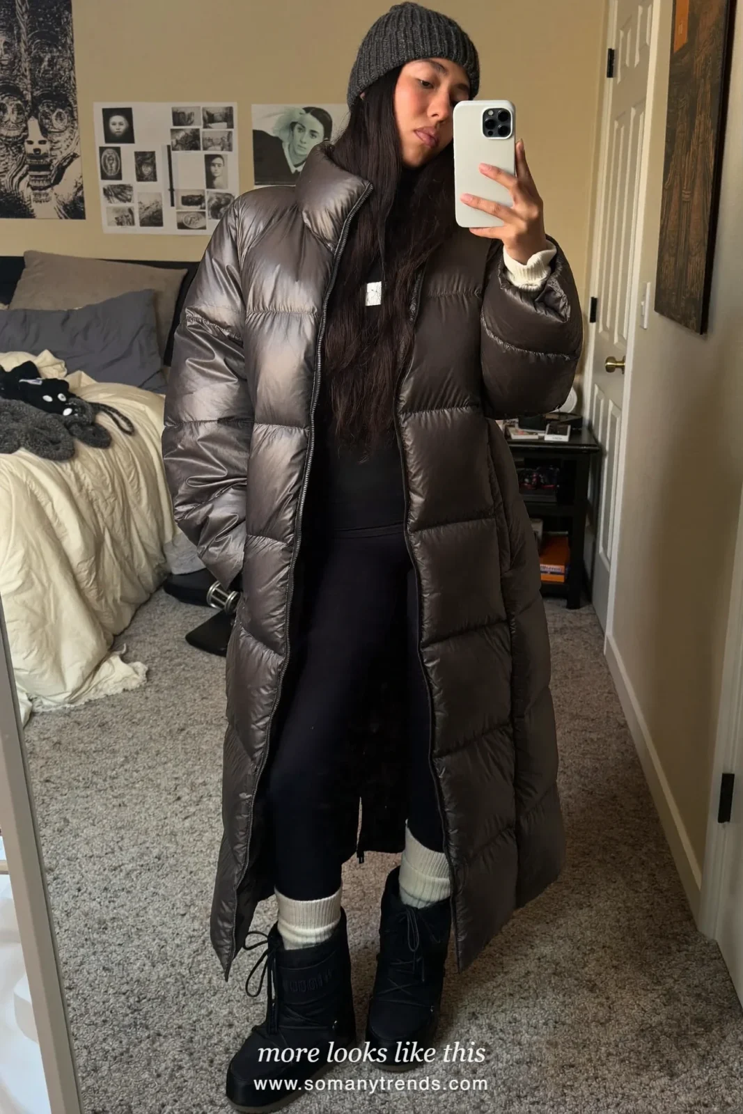 Long charcoal puffer coat with black leggings, chunky socks, snow boots and gray beanie on a snowy street, outfit 24