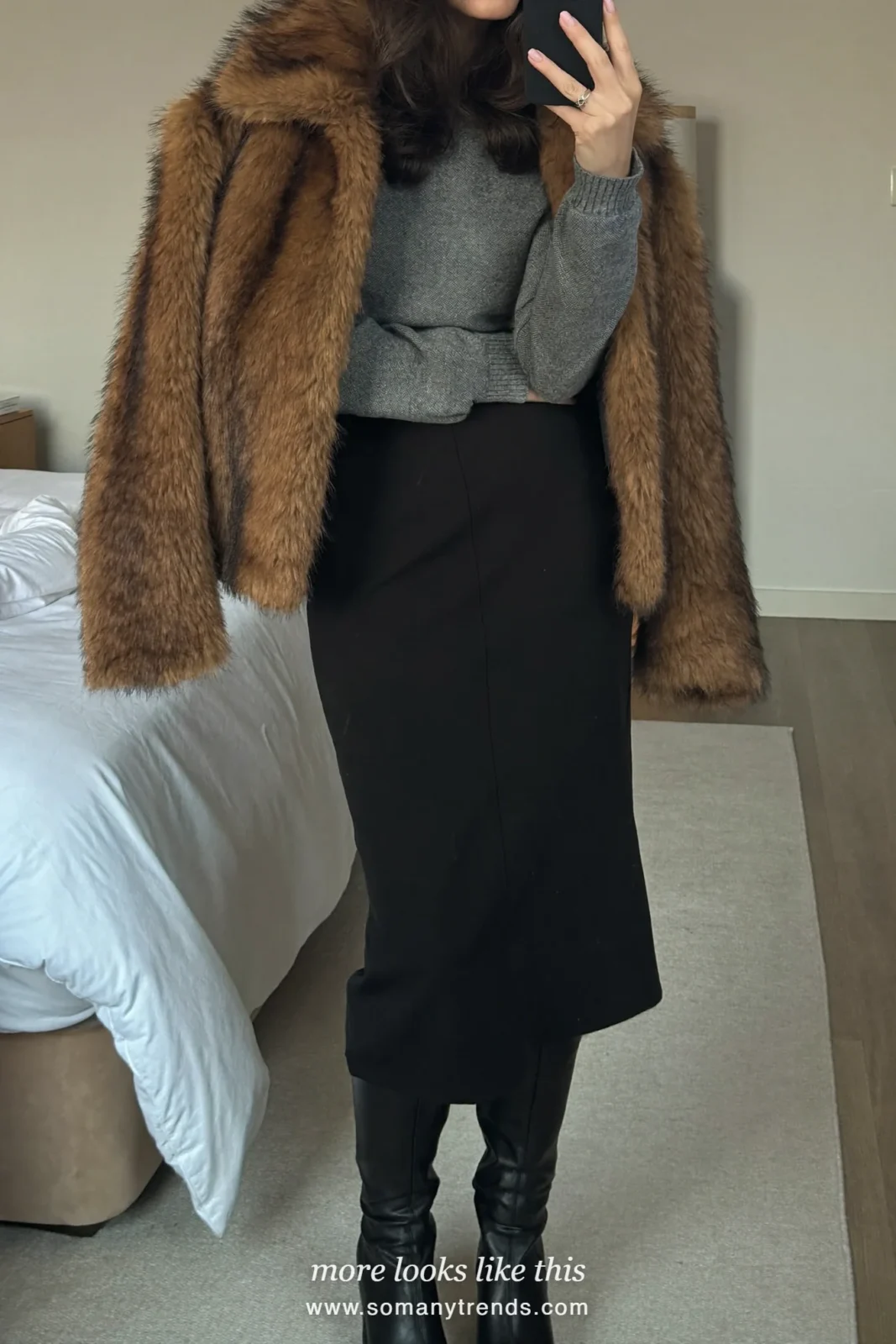 Brown faux fur jacket over a gray sweater, black midi skirt, opaque black tights and black tall boots, outfit 12