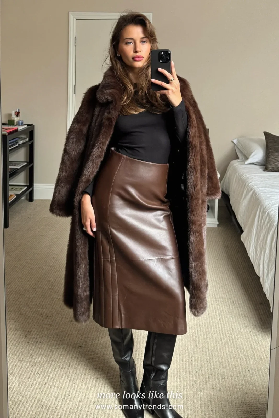 Long brown faux fur coat over a black knit top, chocolate leather midi skirt and tall black boots, outfit 16