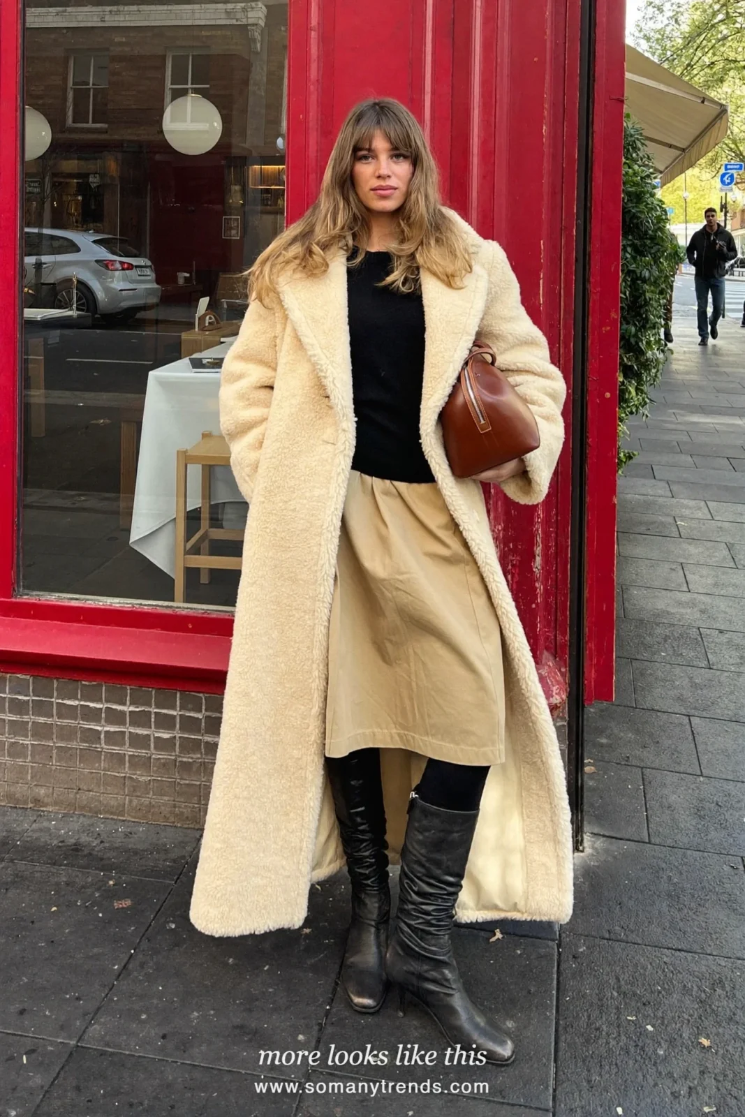 Cream teddy coat over black sweater, sand poplin midi skirt and tall boots, outfit 21