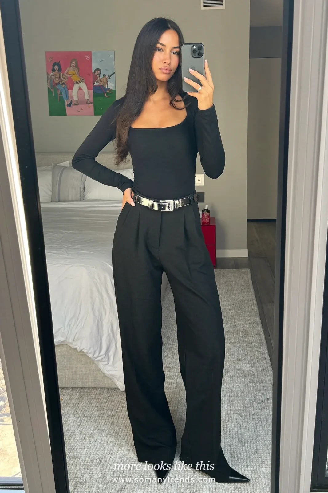 Woman in black square-neck top, black wide-leg pants with silver belt and pointed heels, outfit 16