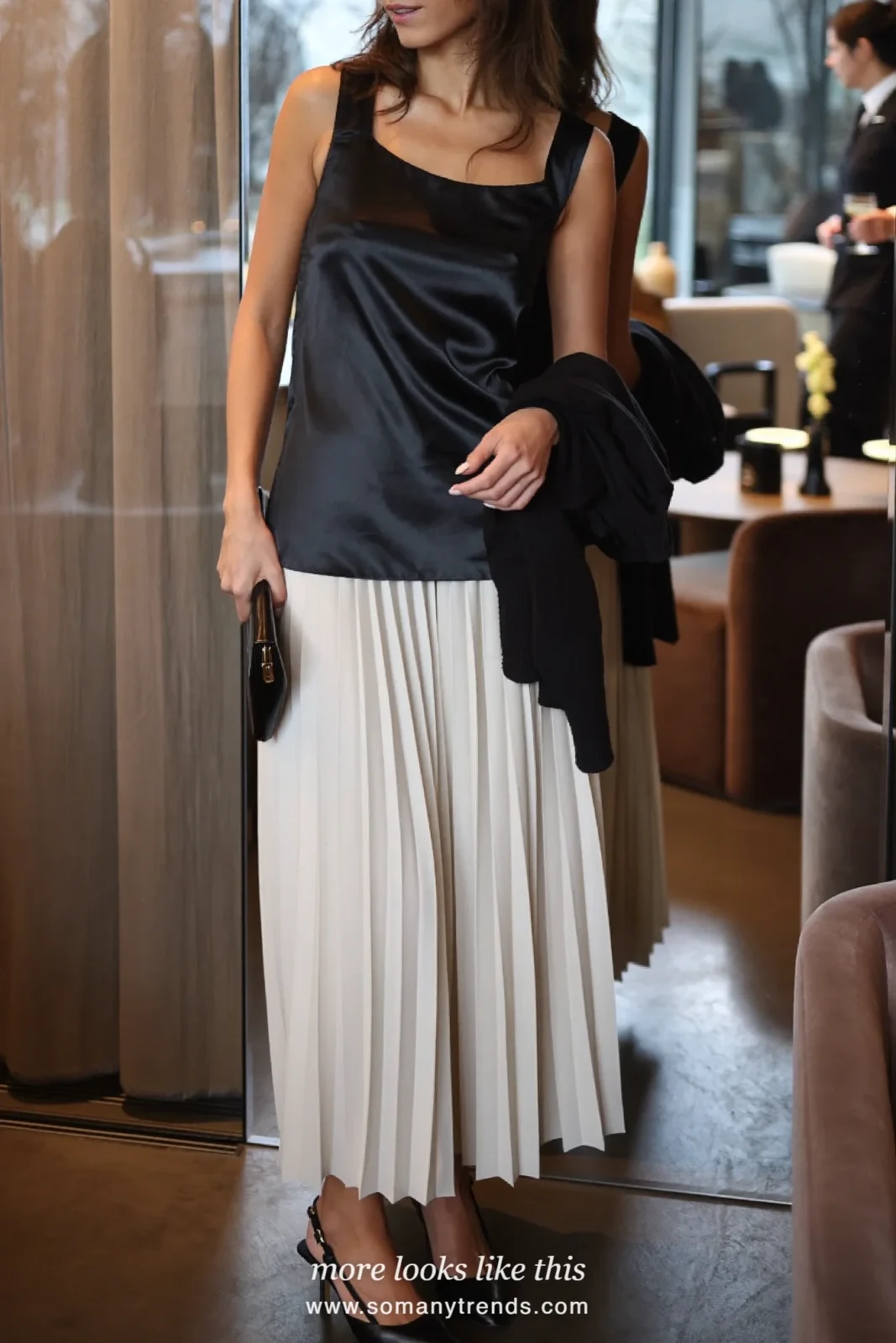 Woman in black satin cami, long ivory pleated skirt and black slingbacks, outfit 18
