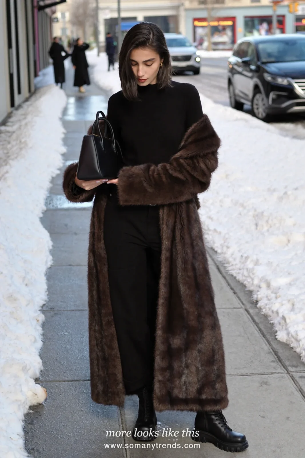 Chocolate brown faux-fur coat with black knit, black wide-leg pants and black lug-sole boots on a snowy street, outfit 17