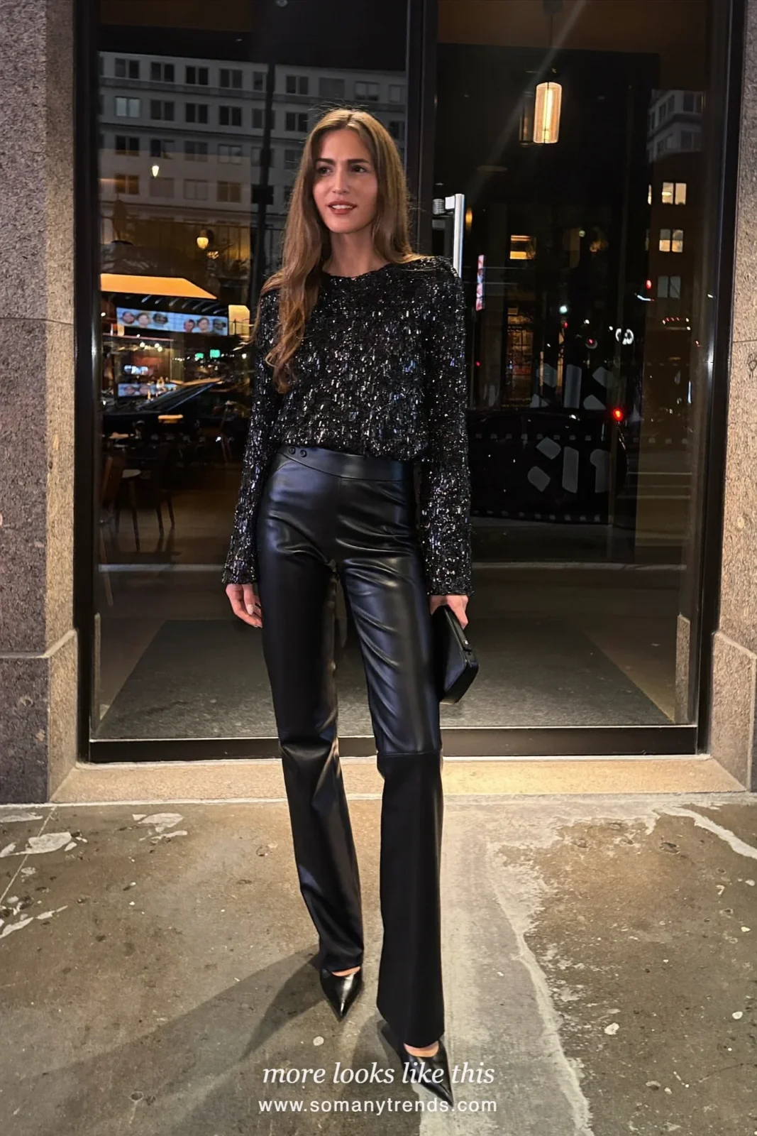 Woman in a black sequin top, black faux leather pants, black pumps and a black clutch outside a restaurant at night, outfit 26