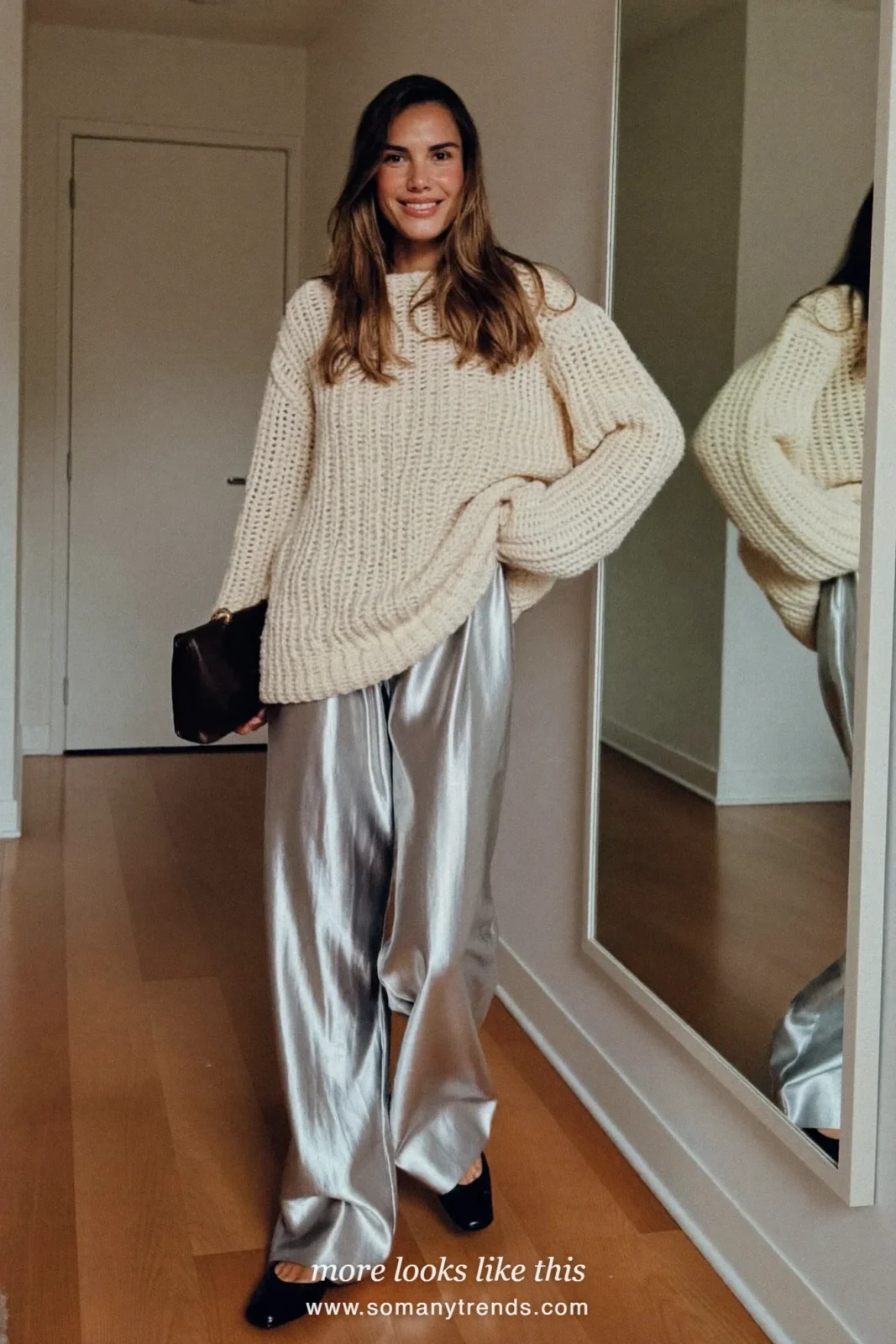 Woman in wide-leg silver metallic pants, chunky cream knit sweater and black flats, house party outfit 3