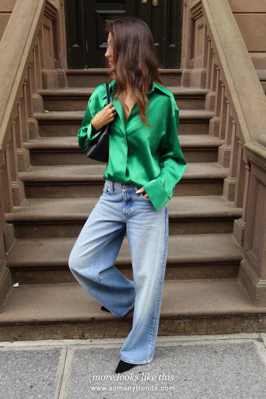 Woman in an emerald satin blouse, light-wash straight jeans and black pointed flats, house party outfit 9