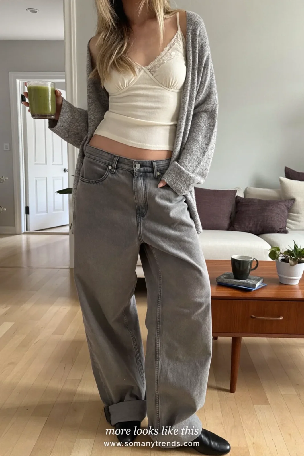 Woman in a cream lace cami, baggy wide-leg jeans and black flat boots, house party outfit 17