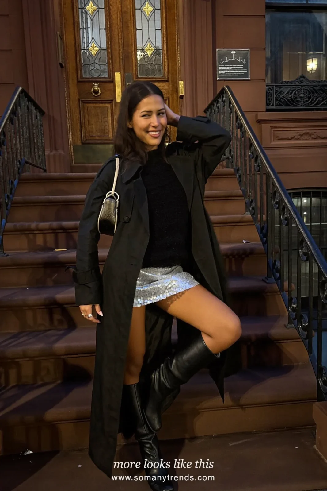 Woman in a long black trench coat over a silver sequin mini skirt, black top and knee-high boots, house party outfit 19