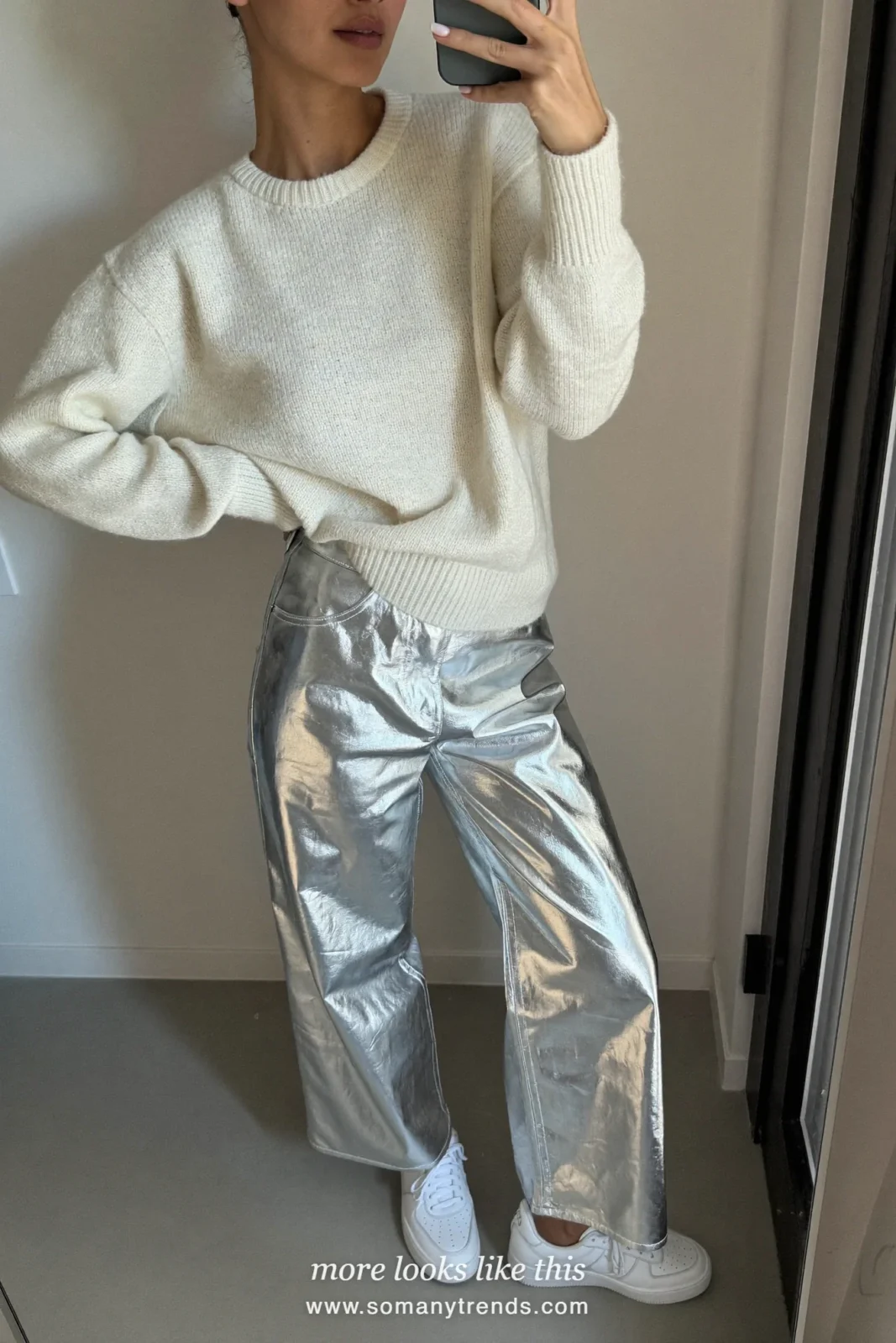 Woman in an ivory ribbed sweater, silver disco wide-leg pants and white sneakers, house party outfit 20