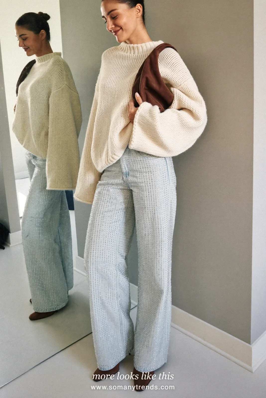 Woman in a cream fisherman sweater, rhinestone straight jeans and brown boots, house party outfit 23