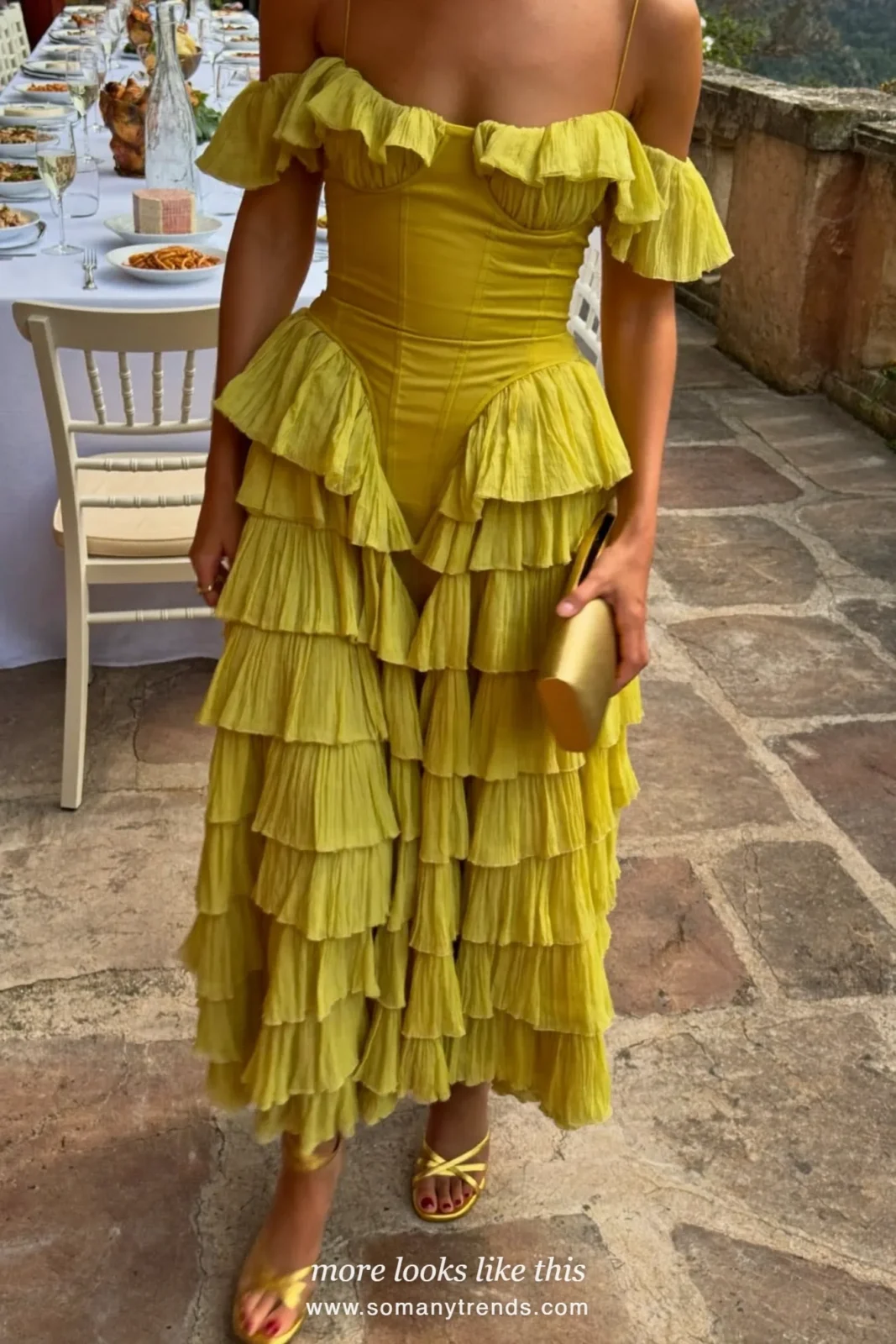 Woman in a chartreuse tiered ruffle gown on a palazzo terrace, outfit 5