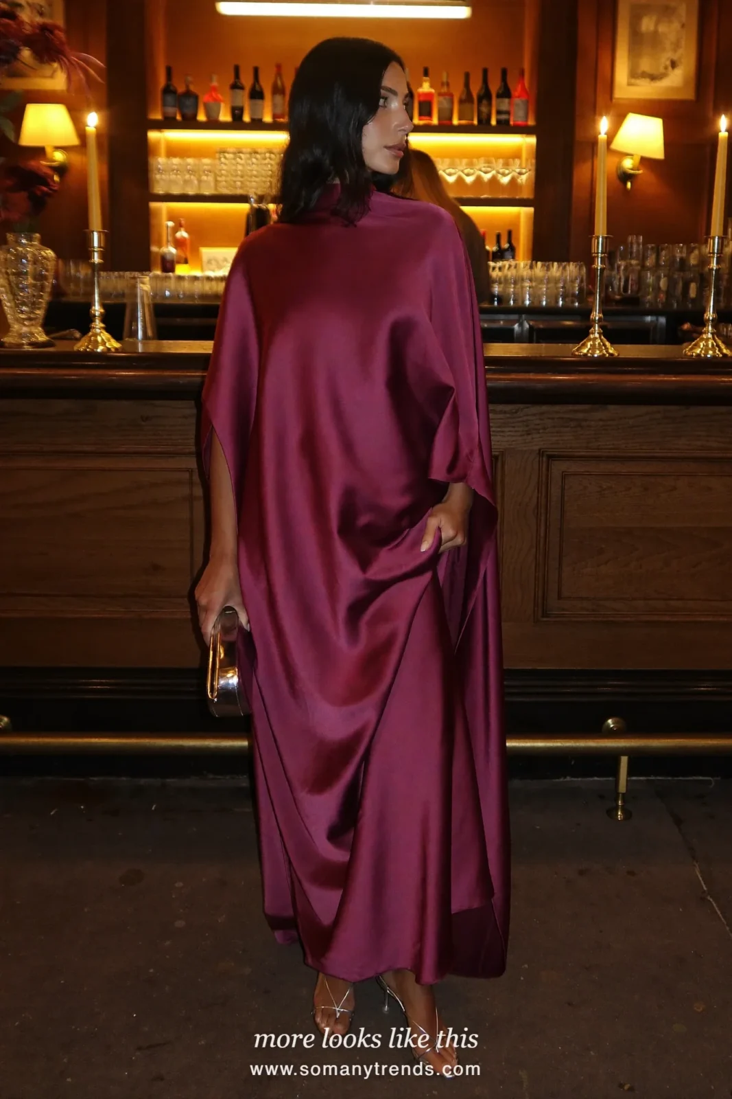 Woman in a plum satin high-neck draped gown at a bar, outfit 9