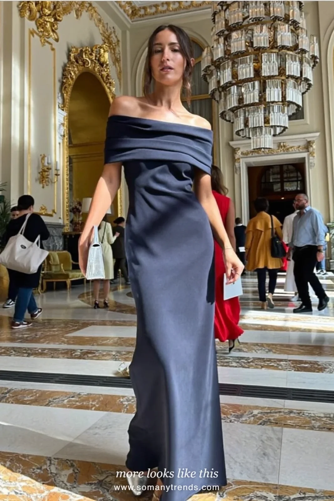 Woman in a midnight navy off-shoulder gown in a hotel lobby, outfit 11
