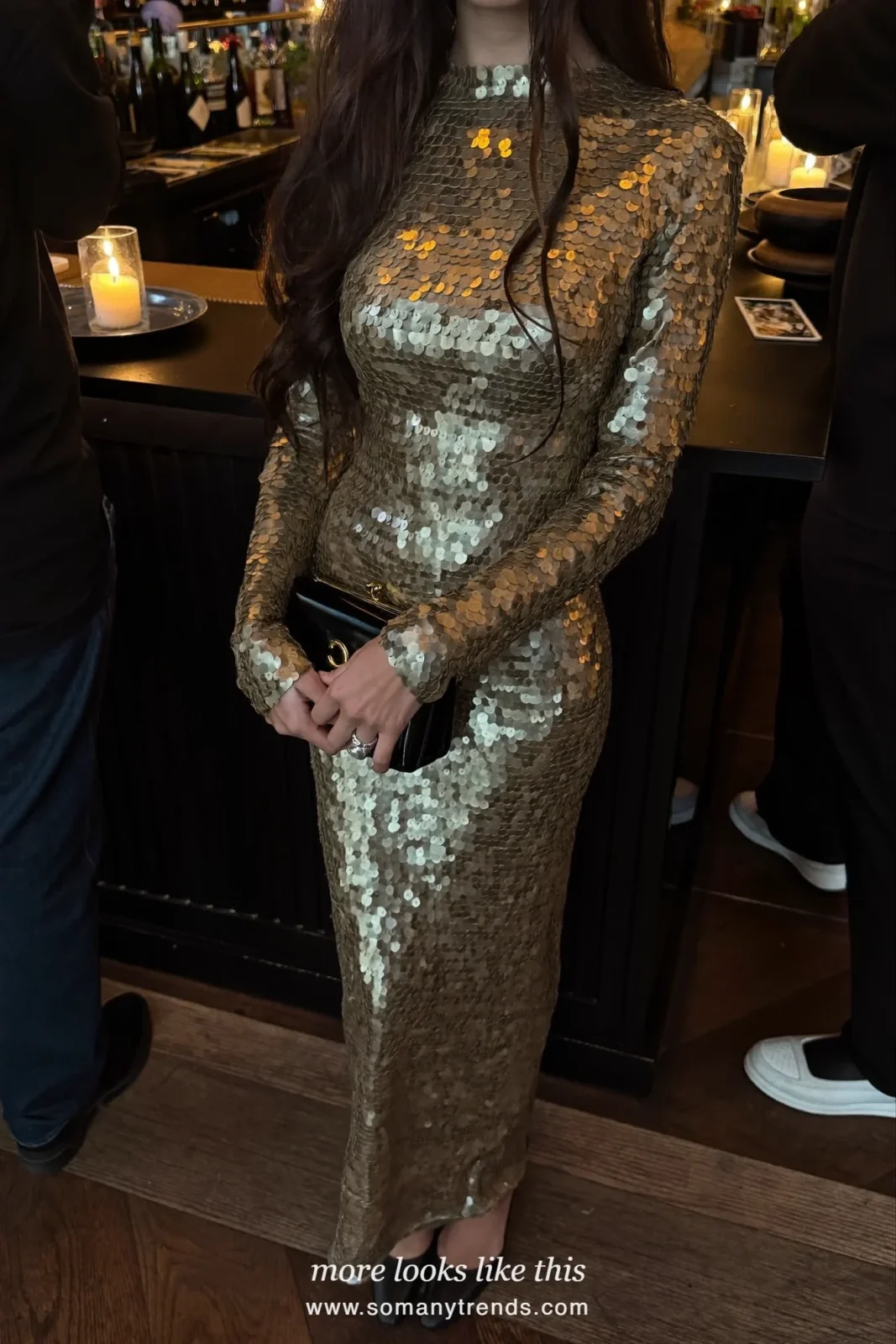 Woman in a gold sequin long-sleeve gown at a bar, outfit 18