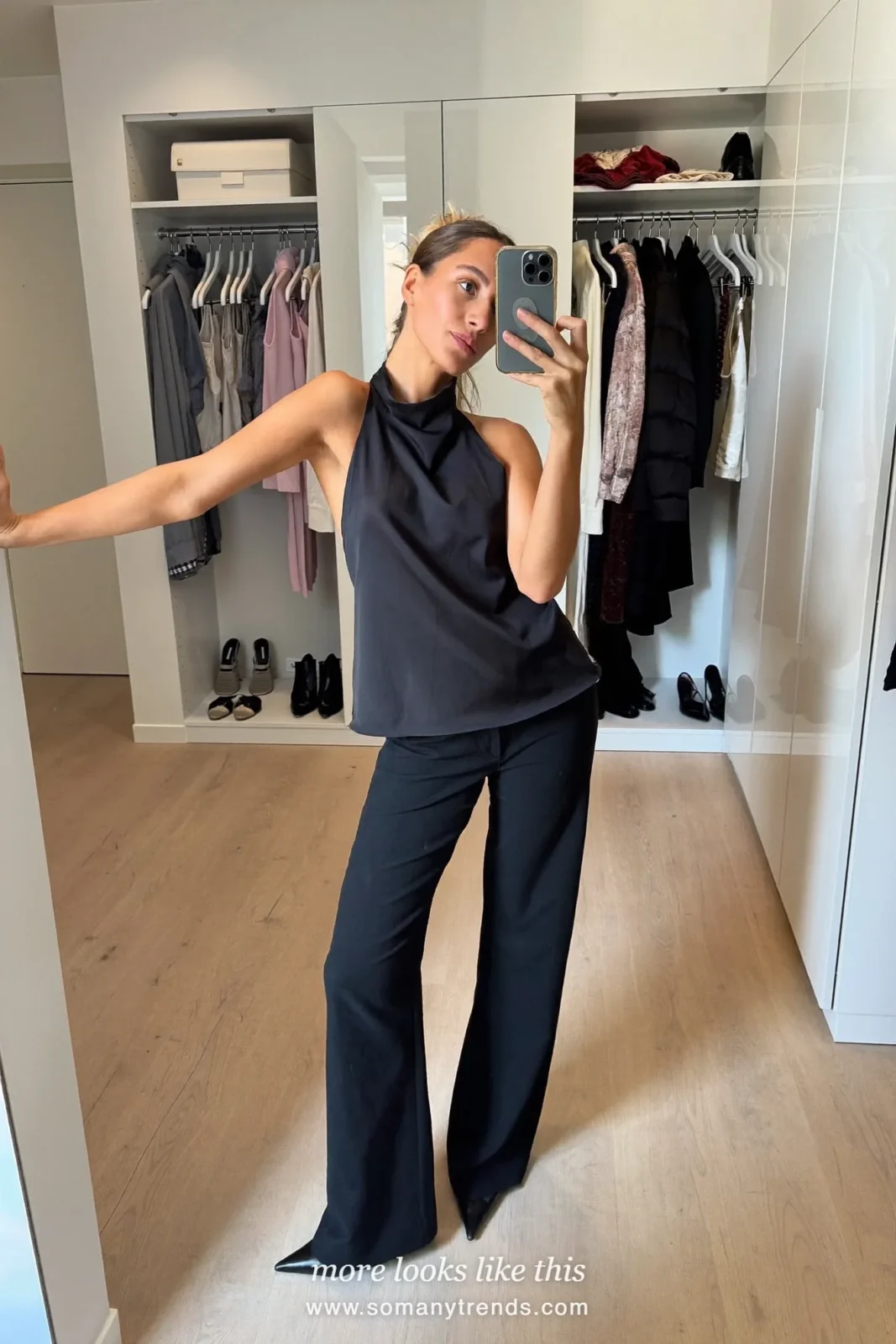 Woman in black wide-leg tuxedo pants with a satin halter top at a bar, outfit 20