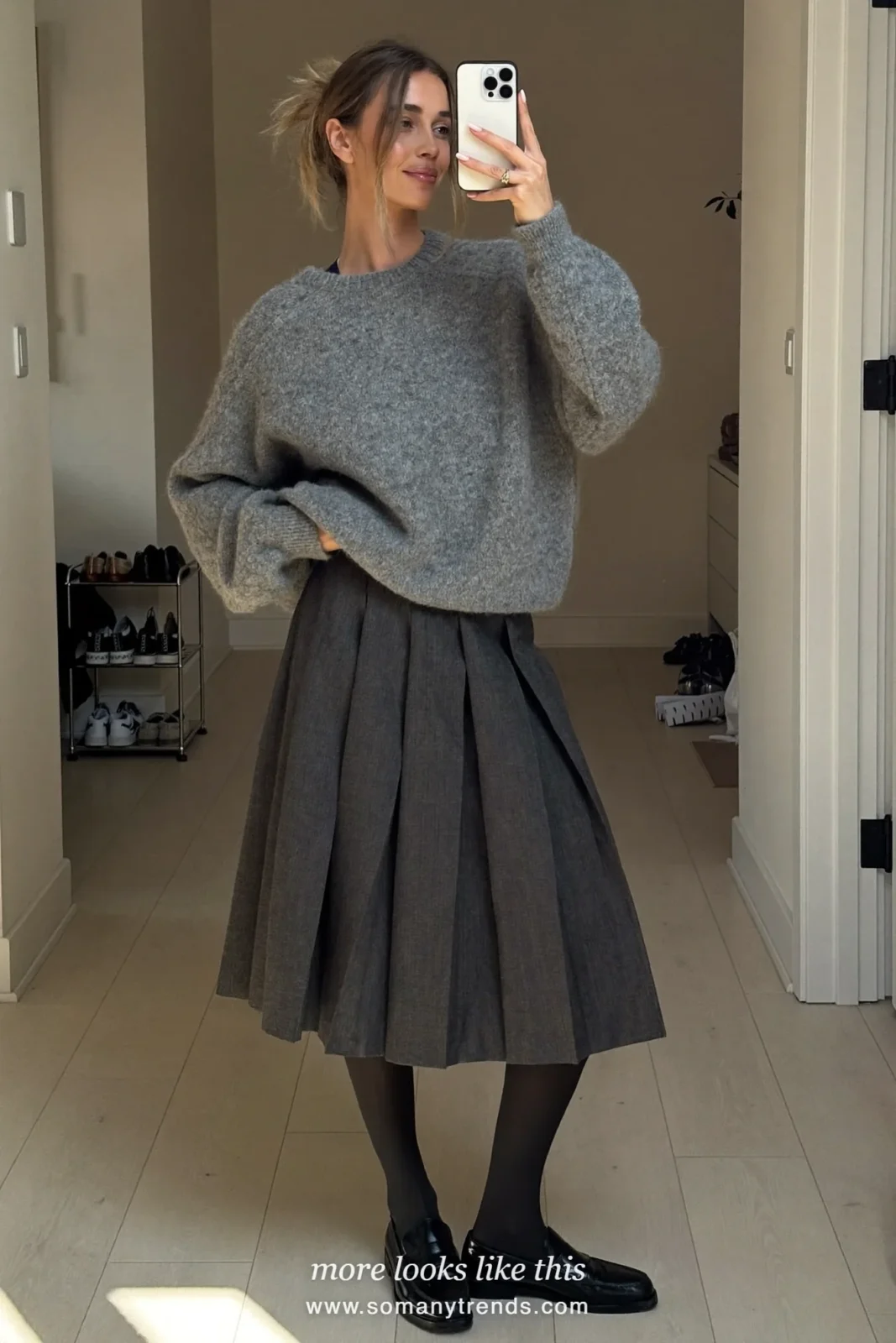 Look 12: charcoal pleated skirt, oversized heather gray sweater, sheer tights and black loafers