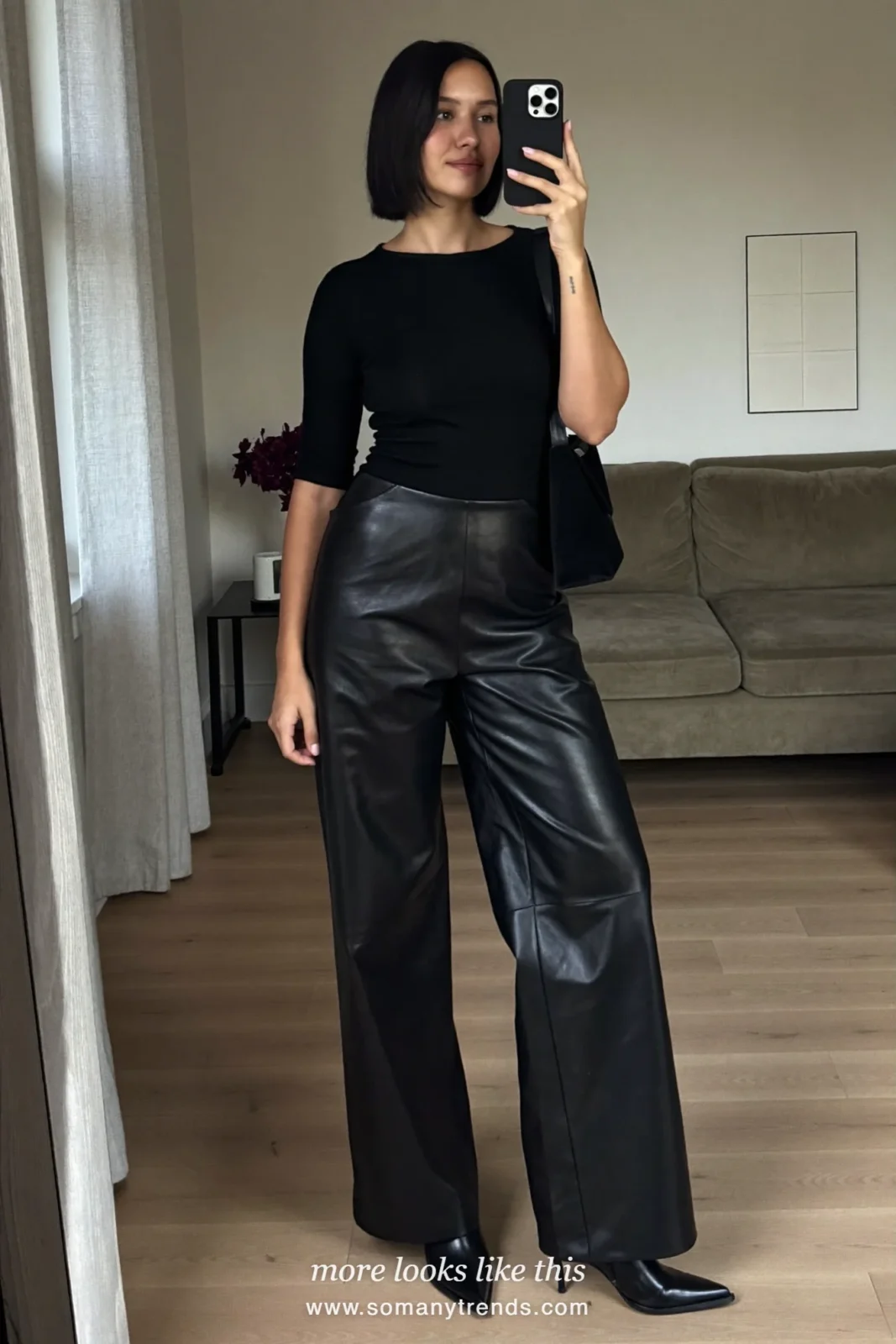 Woman in black leather wide-leg pants, charcoal wool coat, black knit and oatmeal scarf, outfit 8