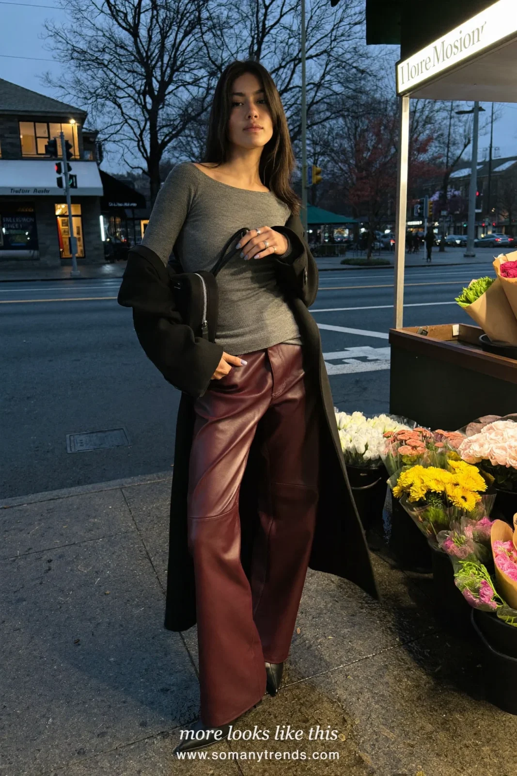 Woman in burgundy leather wide-leg pants, black wool coat, gray knit and black boots, outfit 11