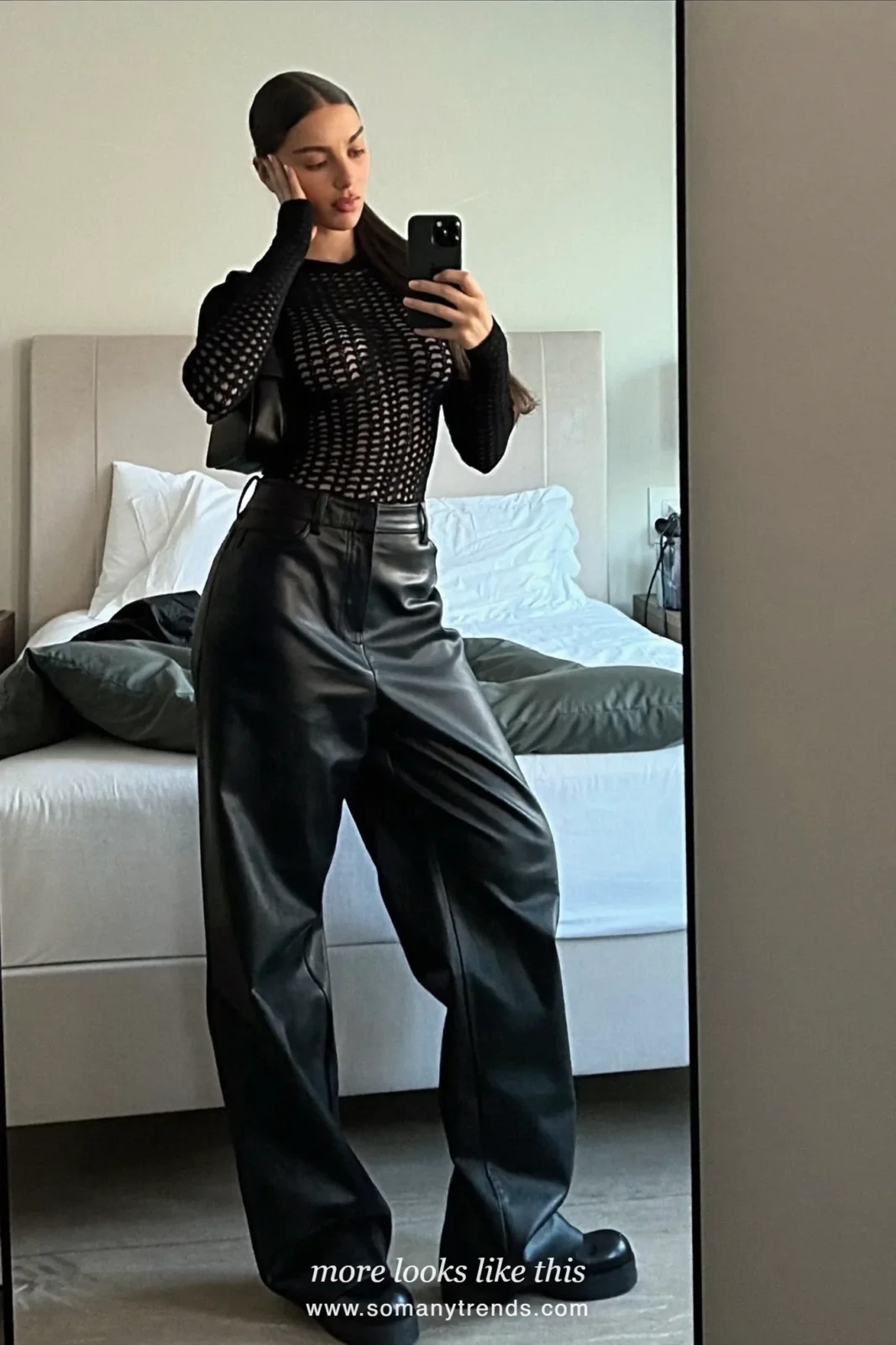 Woman in black leather wide-leg pants, cream shearling jacket, black knit and chunky boots, outfit 12