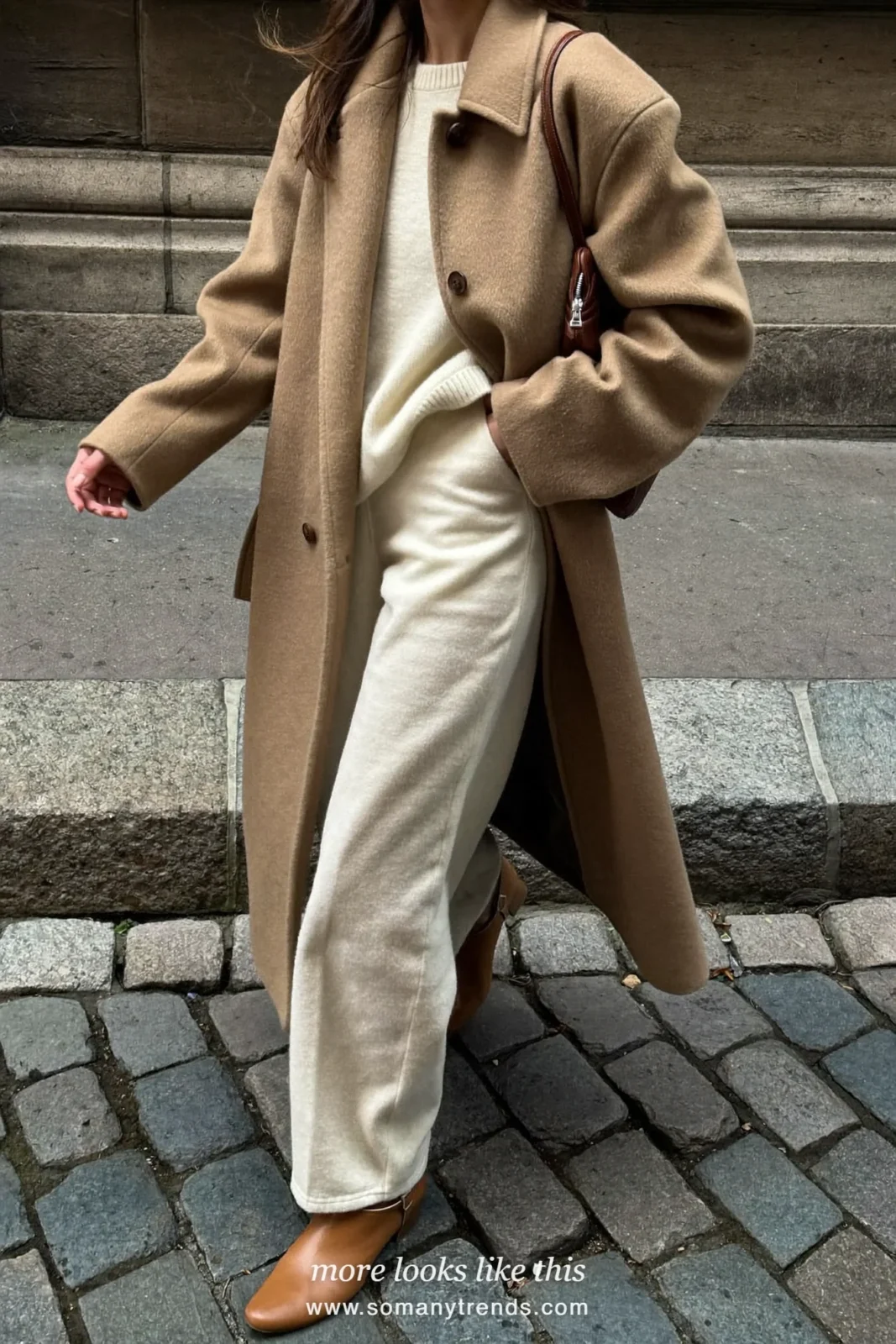Woman in winter white wide-leg pants, camel coat, cream knit and tan boots, outfit 13