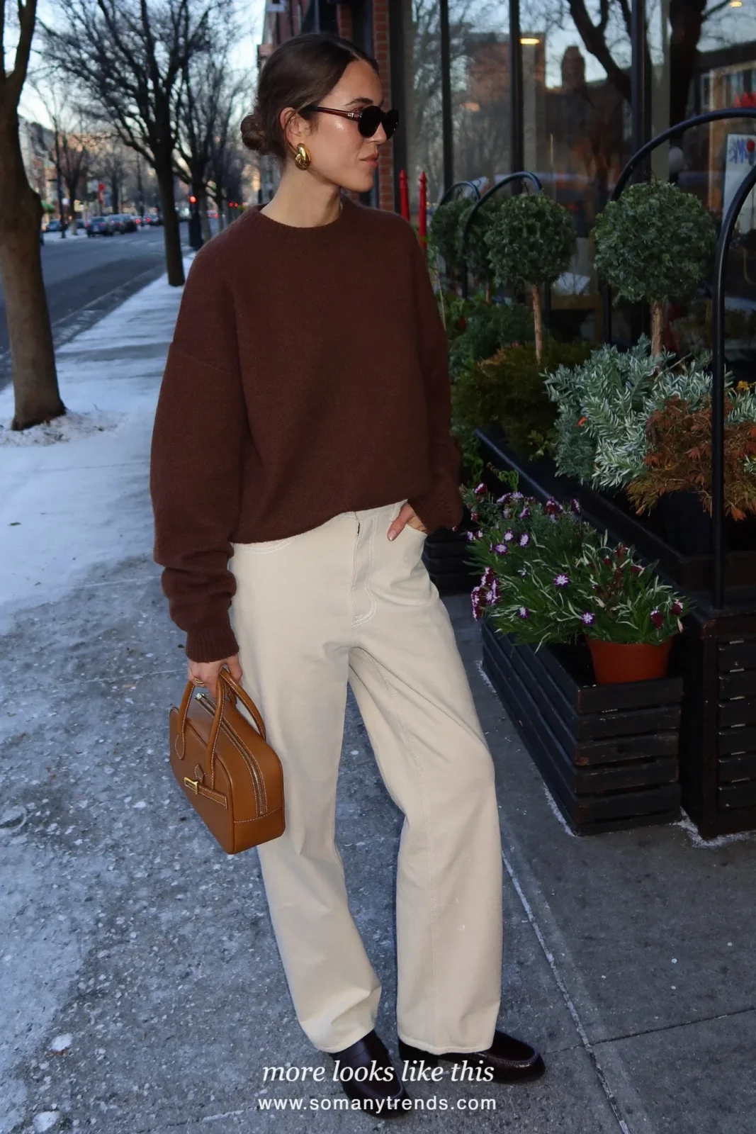 Woman in ivory wide-leg pants, chocolate brown sweater, brown loafers and tan bag, outfit 15