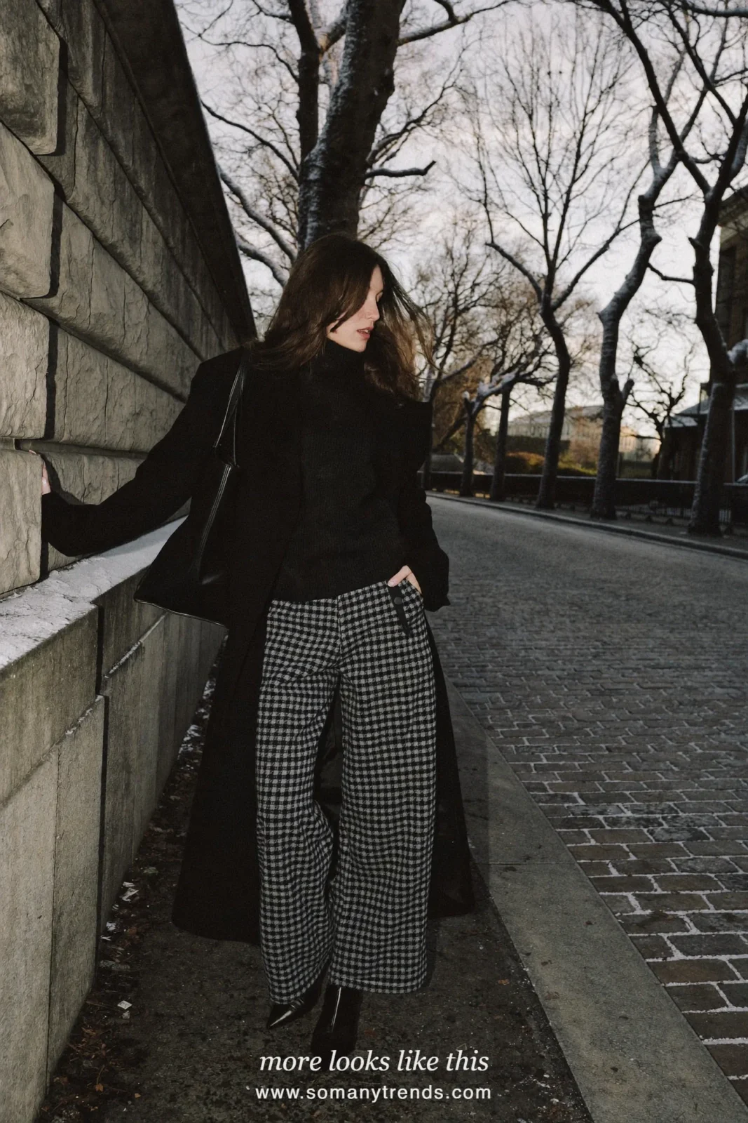 Woman in gray check wide-leg pants, black wool coat, black turtleneck and pointed boots, outfit 19