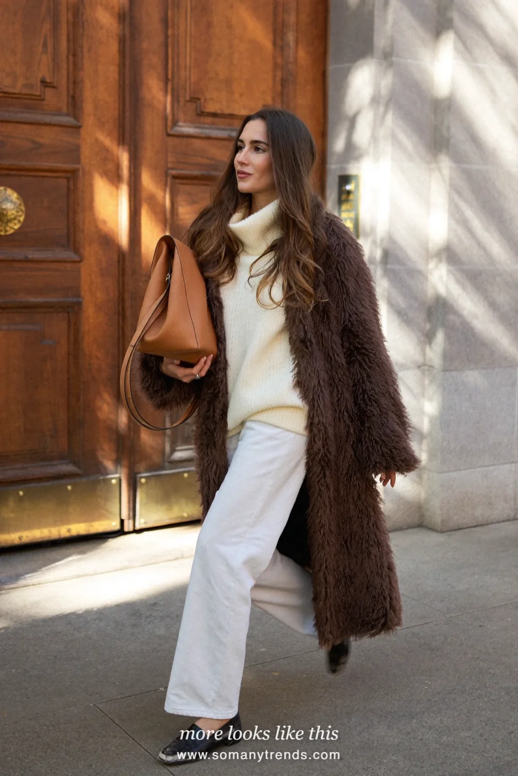 Chocolate shaggy faux fur coat over a cream sweater, white wide jeans and black loafers, outfit 13
