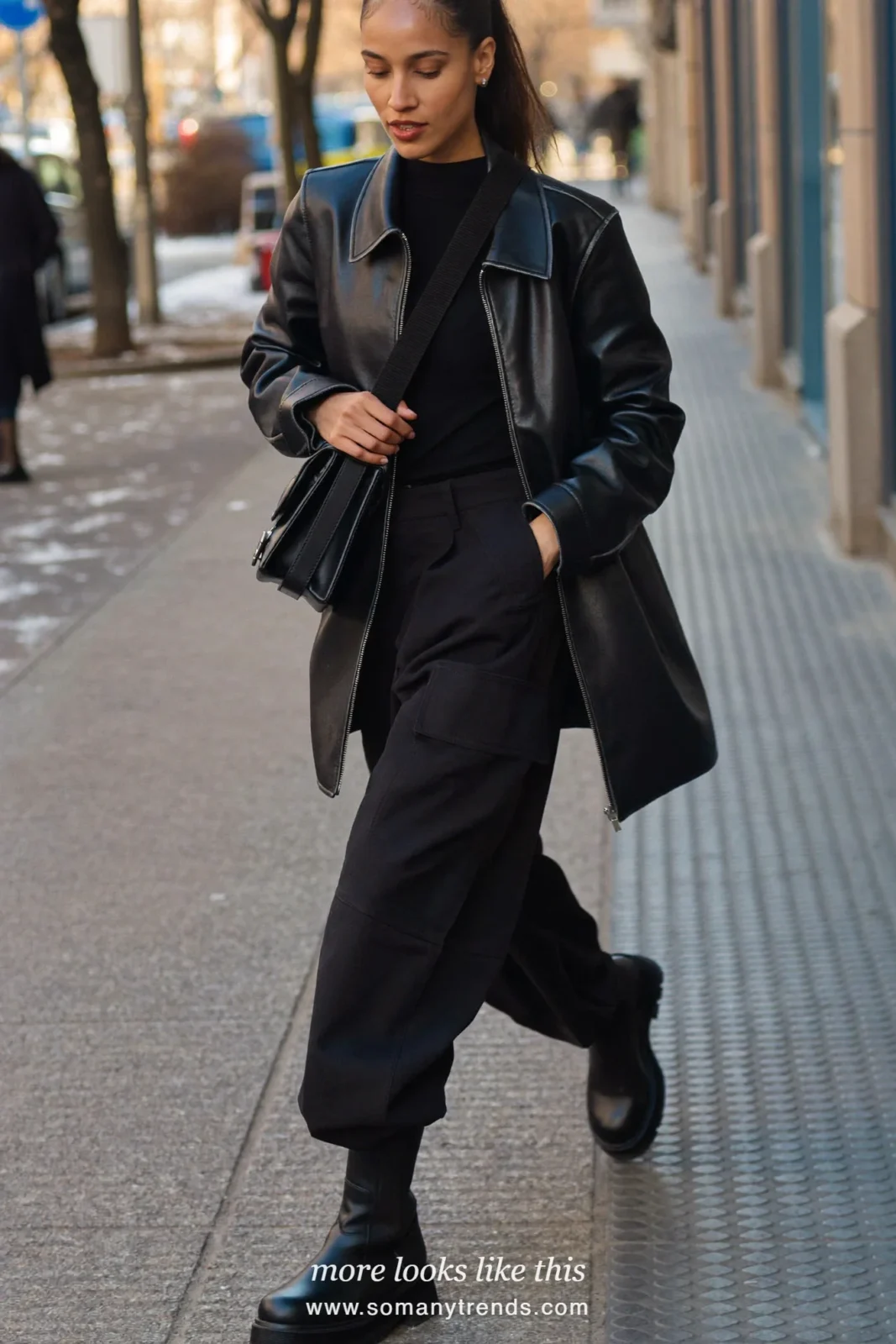 Woman in black cargo pants, black leather jacket, black knit and chunky boots on a city street, outfit 11