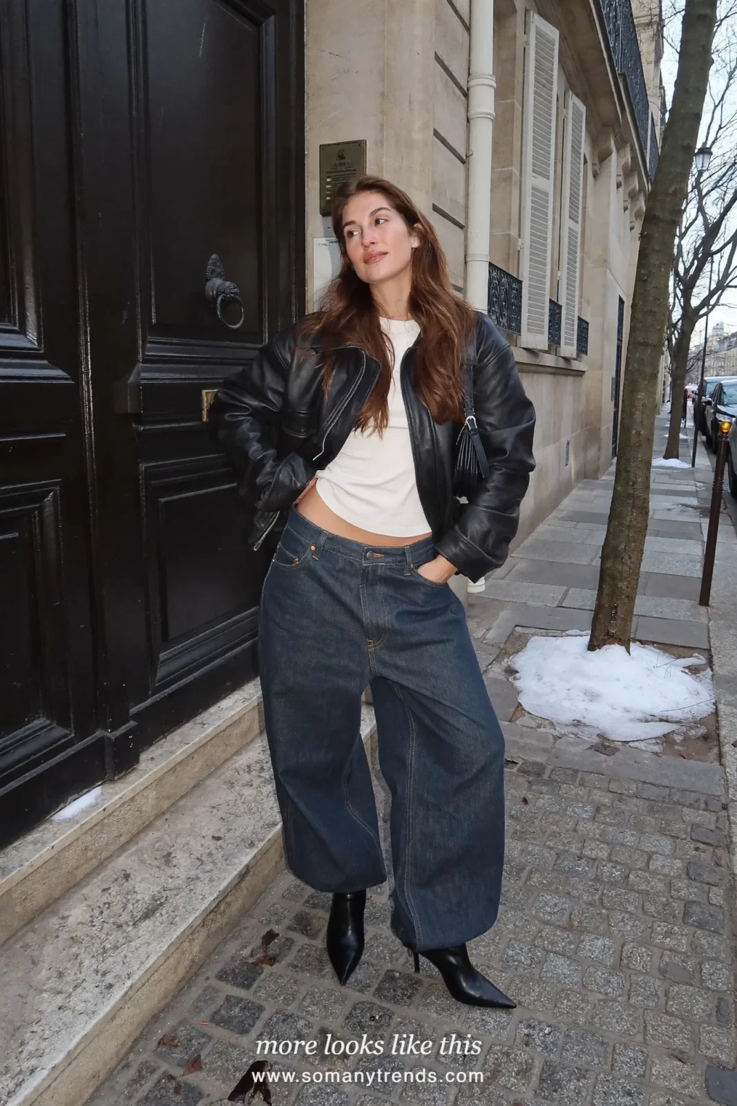 Woman in a black leather jacket, white tee and straight jeans tucked into black kitten-heel boots on a Paris street, outfit 2