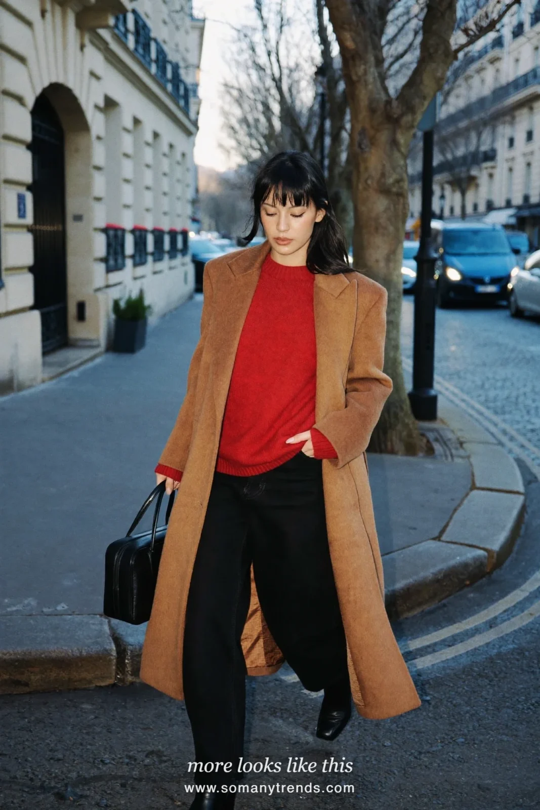Woman in a long camel coat over a cherry red knit sweater, black straight pants and black ankle boots in Paris, outfit 3