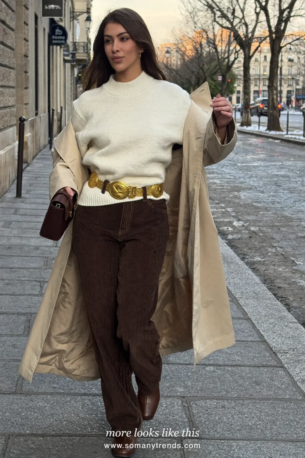 Woman in a beige trench coat with a gold medallion belt over brown corduroy jeans and flat leather boots in Paris, outfit 6