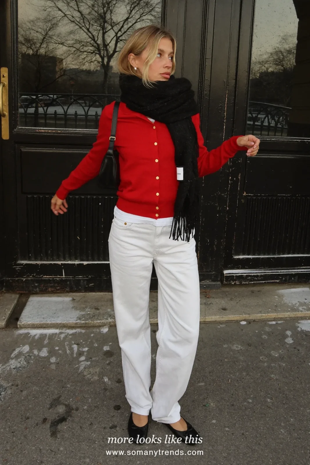Woman in a cherry red cardigan, white straight jeans and black ballet flats on a Paris street, outfit 19