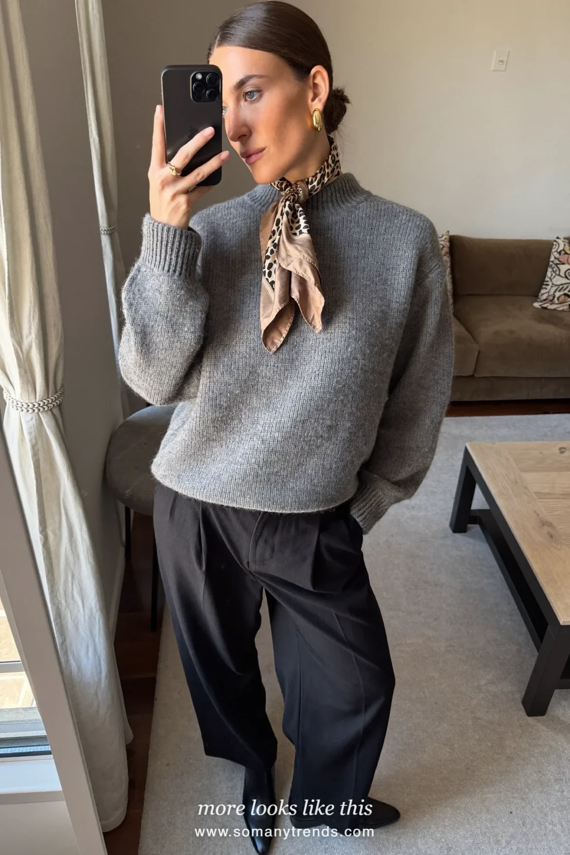 Woman in a long black coat with a leopard print scarf, gray knit and black pants on a Paris street, outfit 24