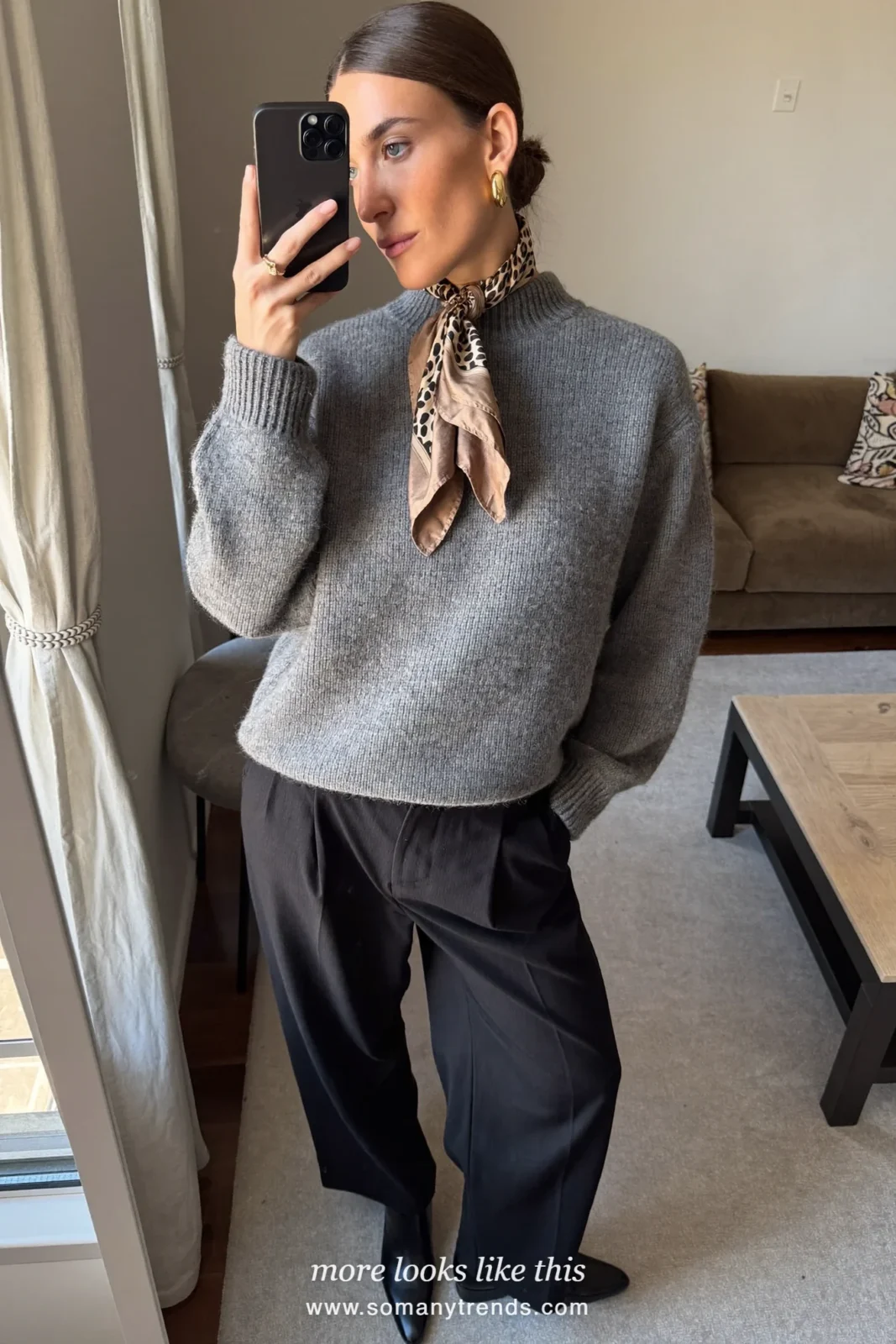 Woman in a long black coat with a leopard print scarf, gray knit and black pants on a Paris street, outfit 24