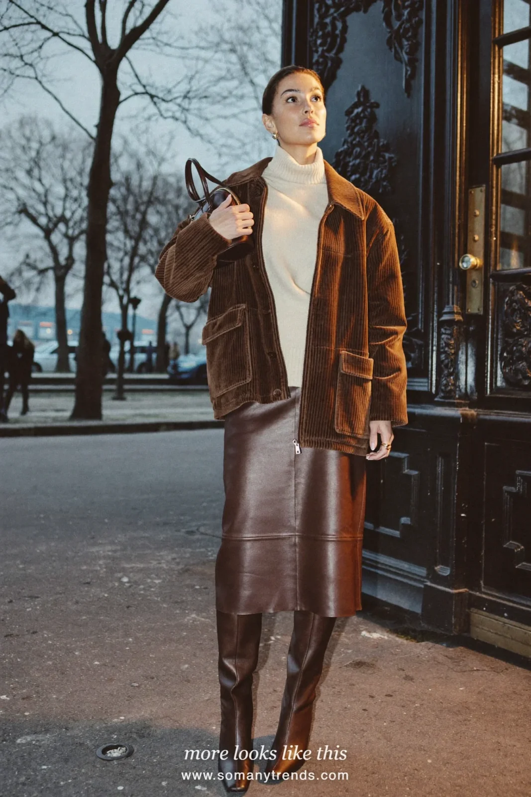 Woman in a brown corduroy jacket, cream turtleneck, chocolate leather midi skirt and tall brown boots in Paris, outfit 25
