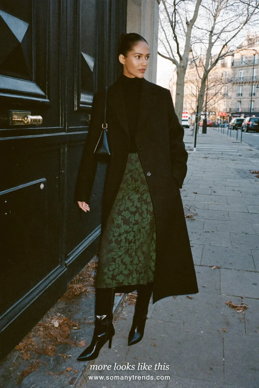 Woman in a black turtleneck, green and gold brocade midi skirt, knee-high black boots and black coat in Paris, outfit 31