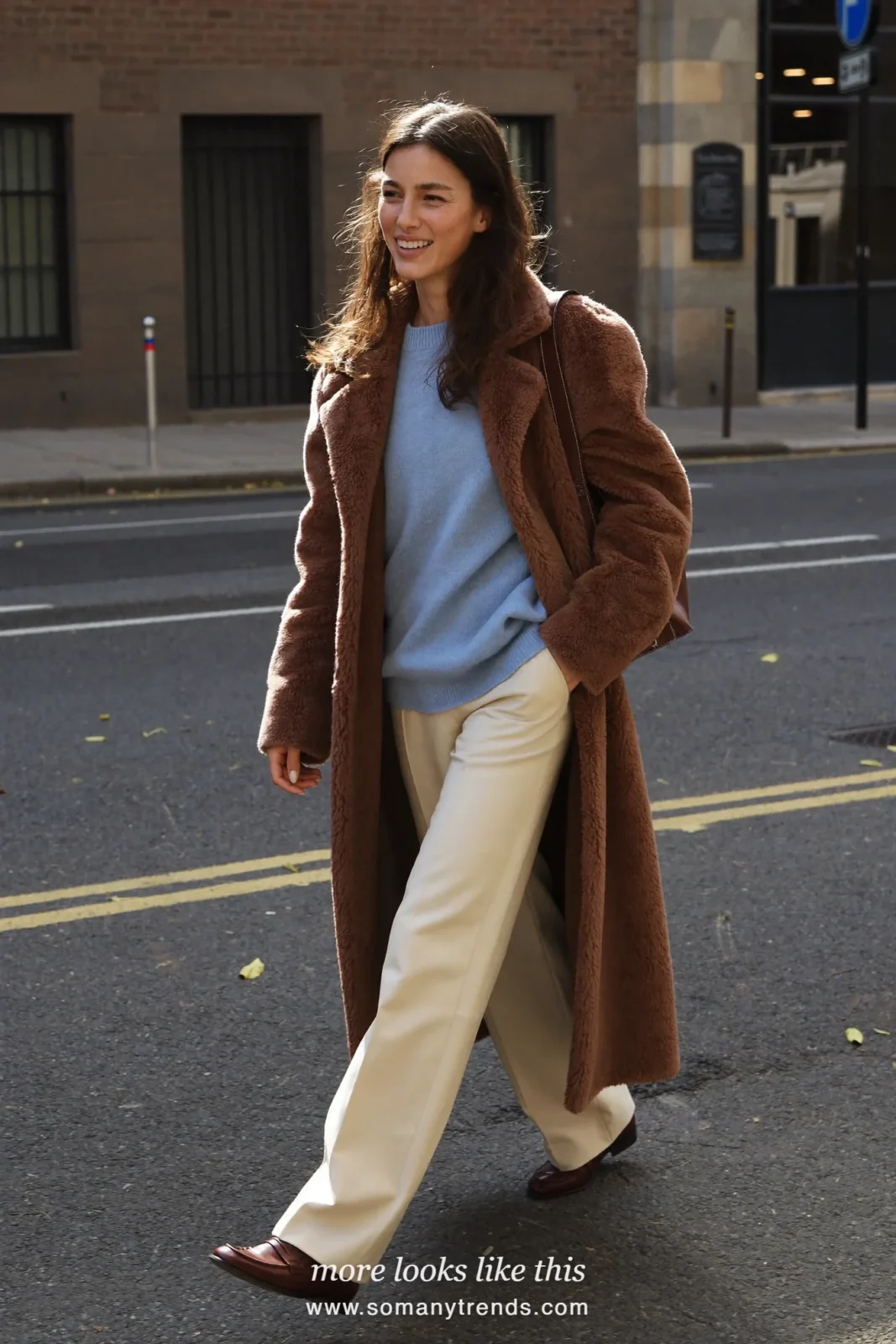 Brown teddy coat over baby blue knit, cream tailored pants and brown loafers, outfit 25