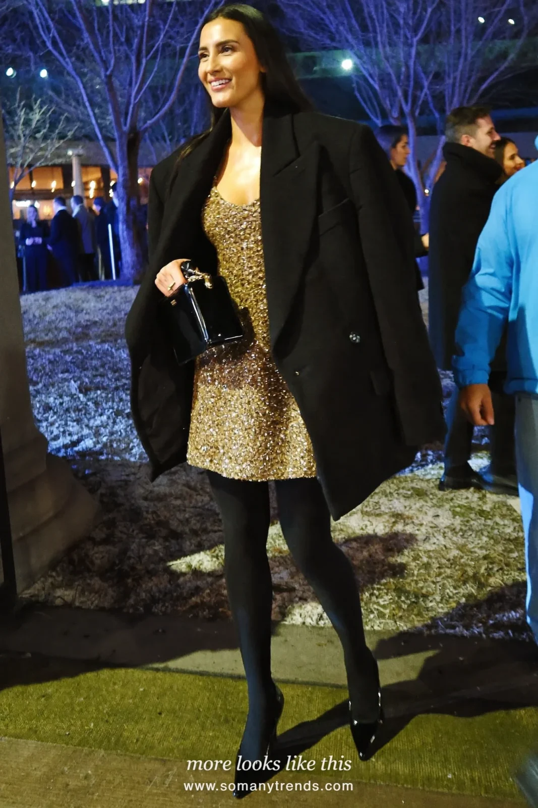 Woman in a gold sequin mini dress, oversize black blazer, sheer black tights and black pumps outside a venue on New Year's Eve, outfit 21