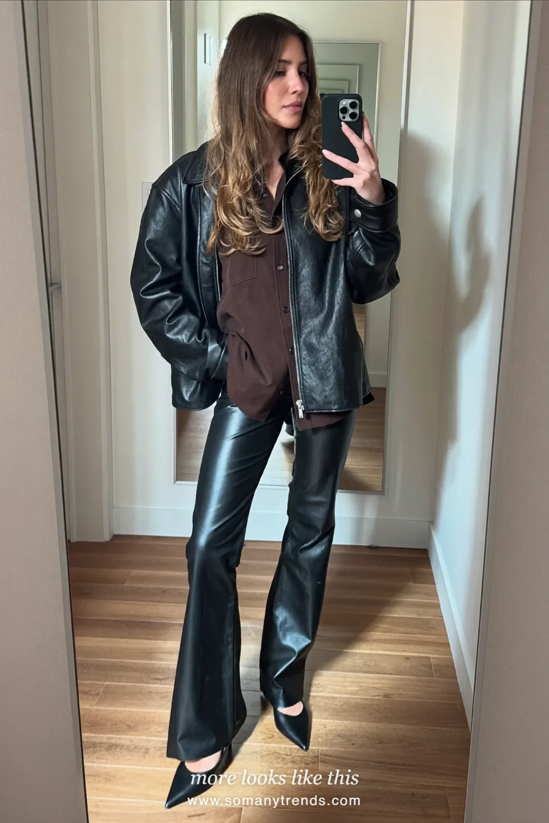 Woman in a brown shirt, black leather jacket, black flare pants and black almond-toe pumps, outfit 8