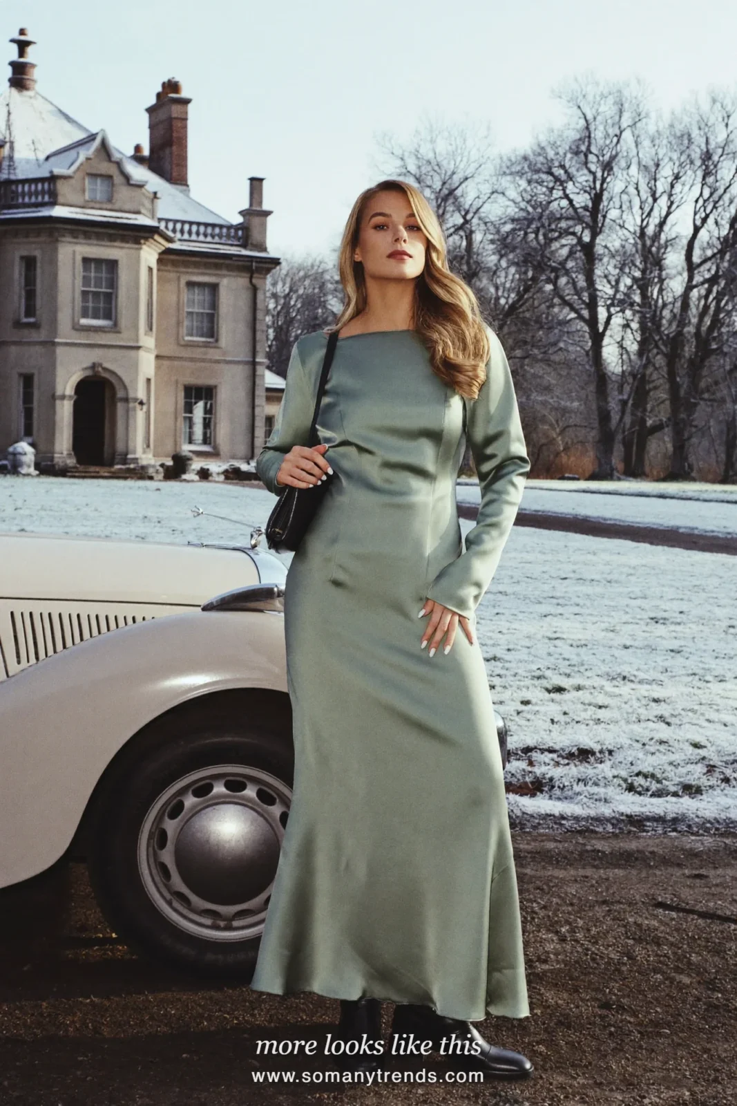 Woman in a sage green satin long-sleeve maxi dress with black block-heel boots next to a vintage car at a country manor, outfit 3