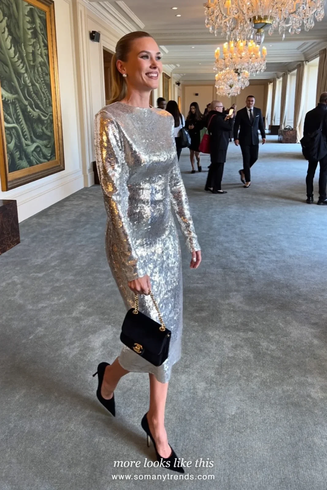 Woman in a silver sequin midi dress with black velvet clutch and heels in a hotel ballroom, outfit 9