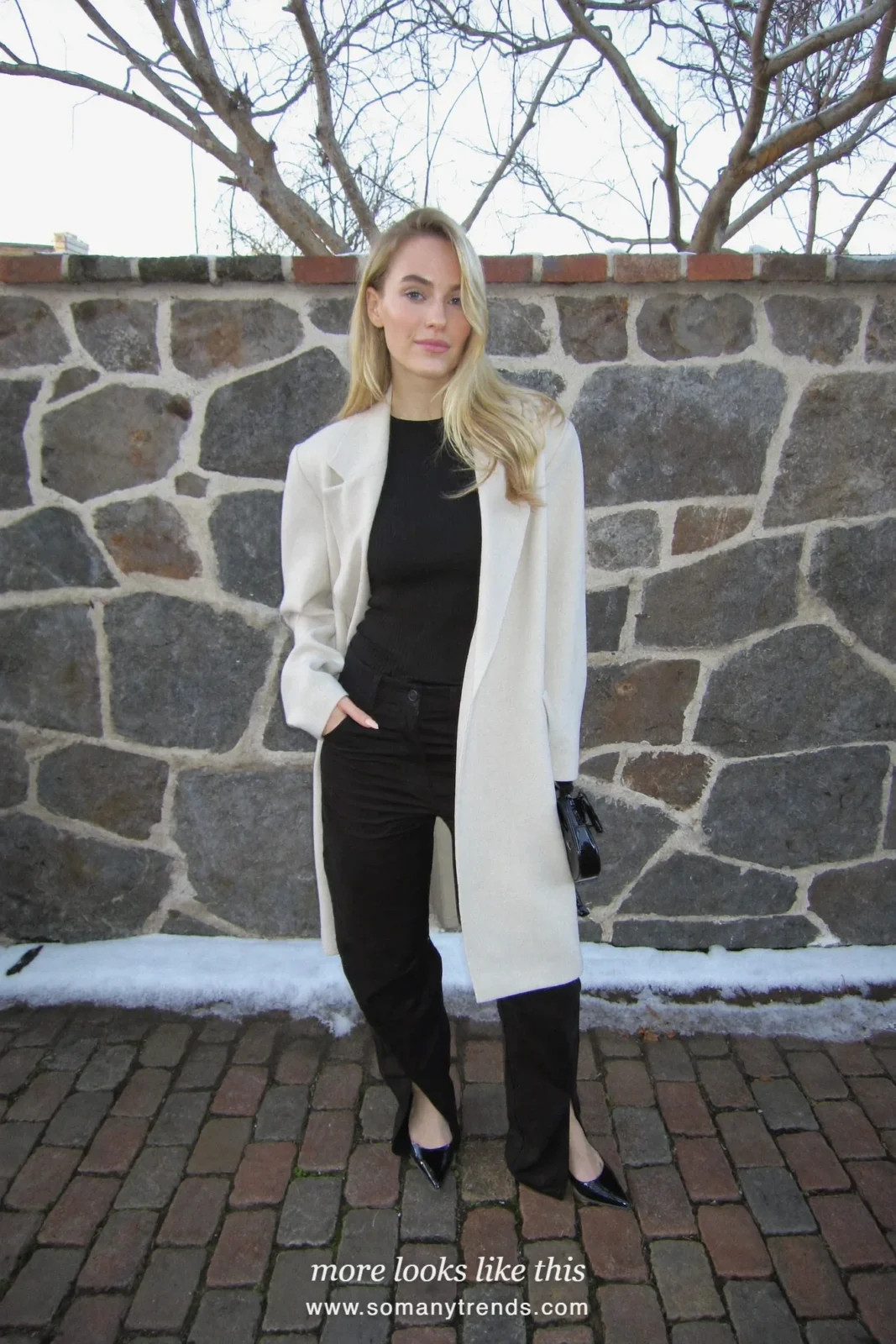 Woman in black split-hem wide-leg pants, long cream blazer, black knit and pointed heels, outfit 26