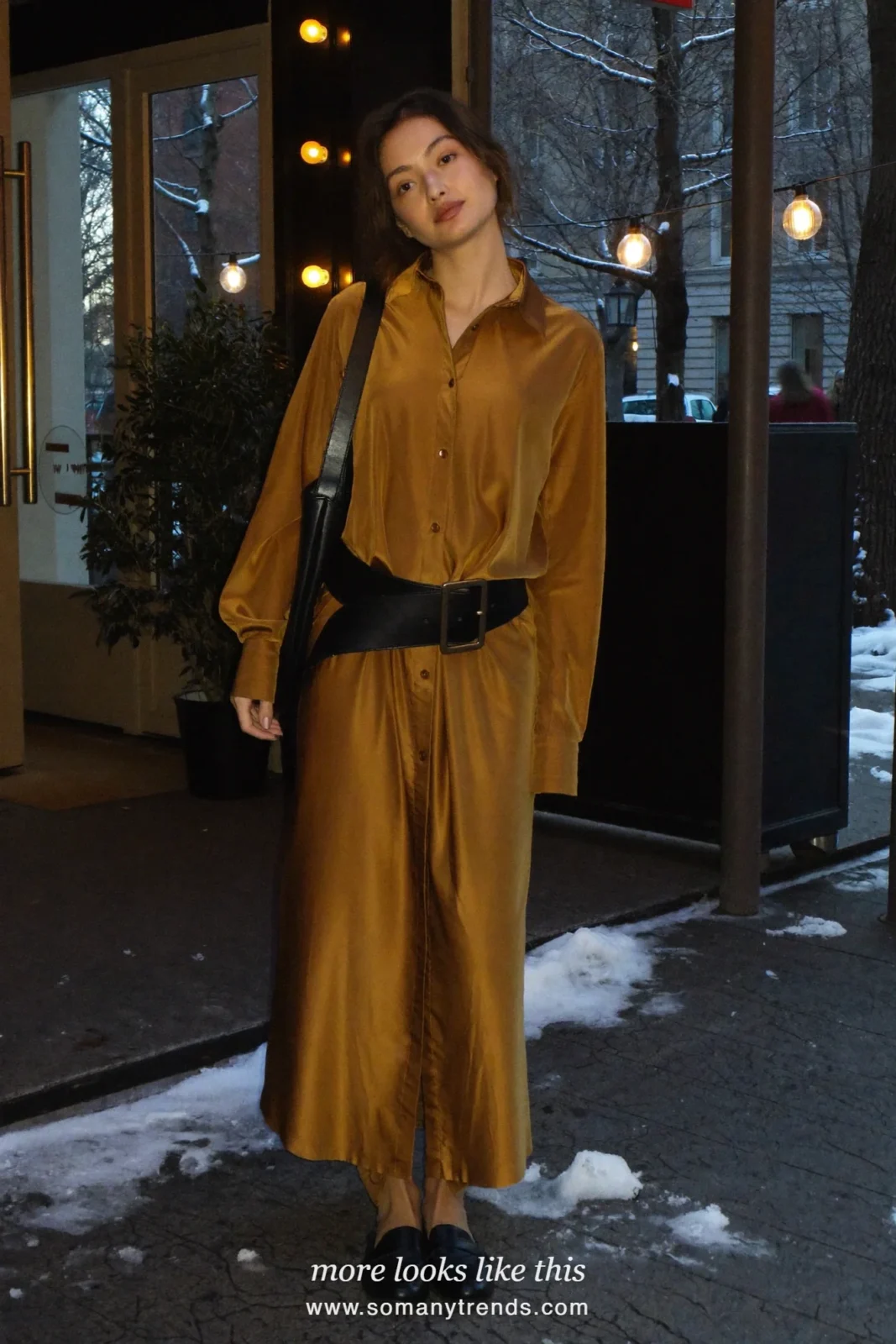 Woman in a gold shirt dress with a wide black belt and black loafers outside a restaurant, outfit 23
