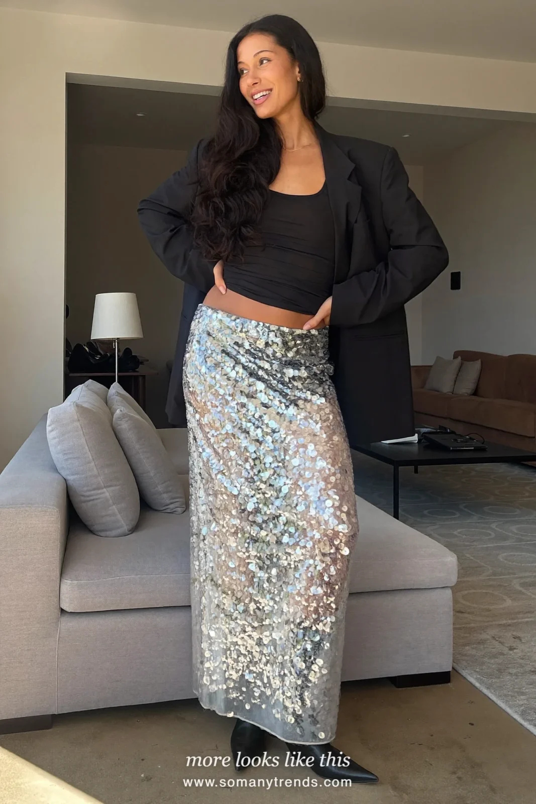 Woman in a silver sequin maxi skirt, black tank and oversized black blazer with ankle boots, house party outfit 10