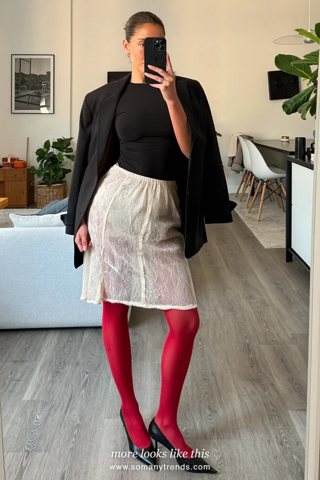 Woman in an ivory lace midi skirt, black blazer, black top, sheer red tights and black pumps, outfit 9