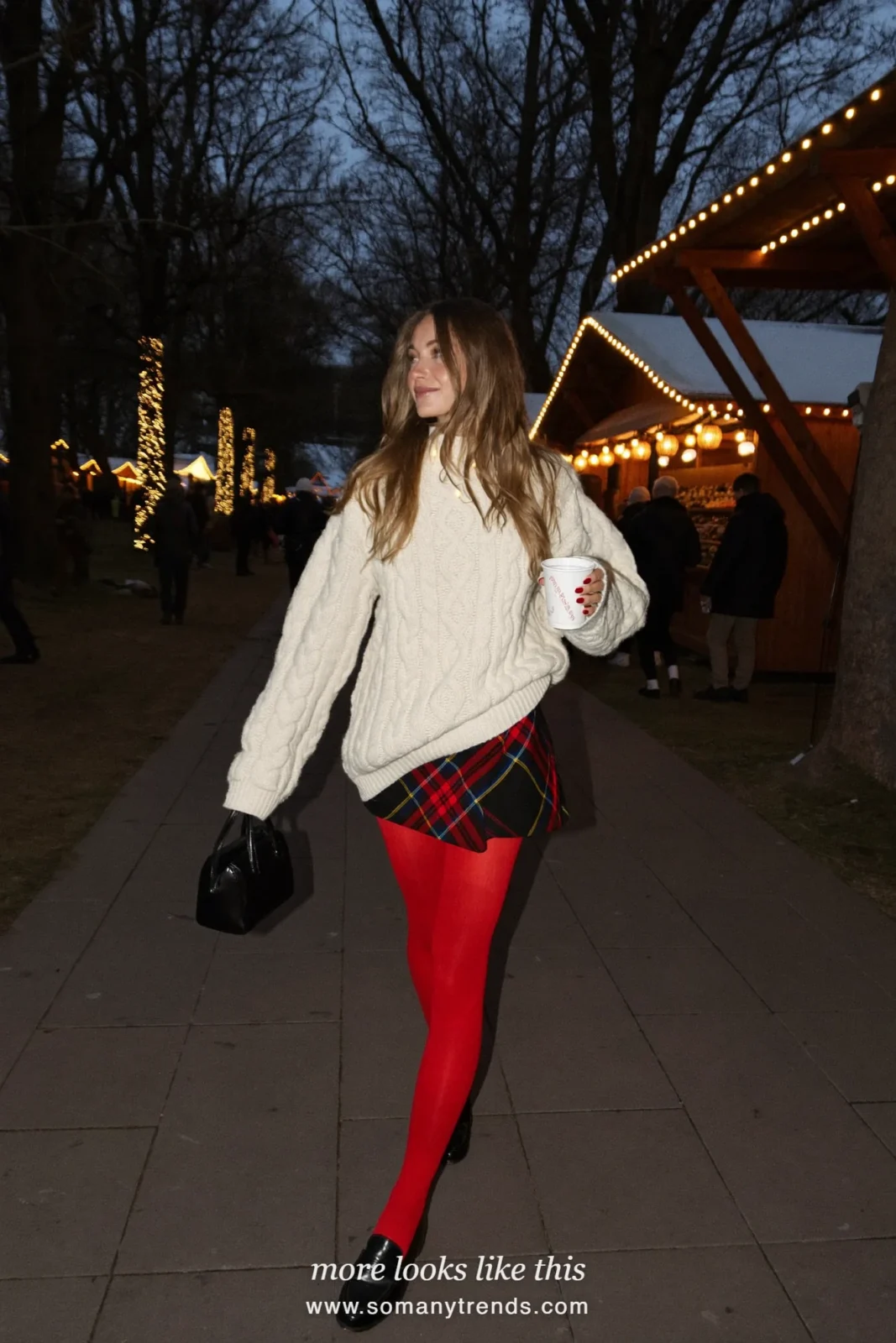 Woman in a cream cable knit sweater, black and red tartan mini skirt, opaque red tights and black loafers, outfit 13
